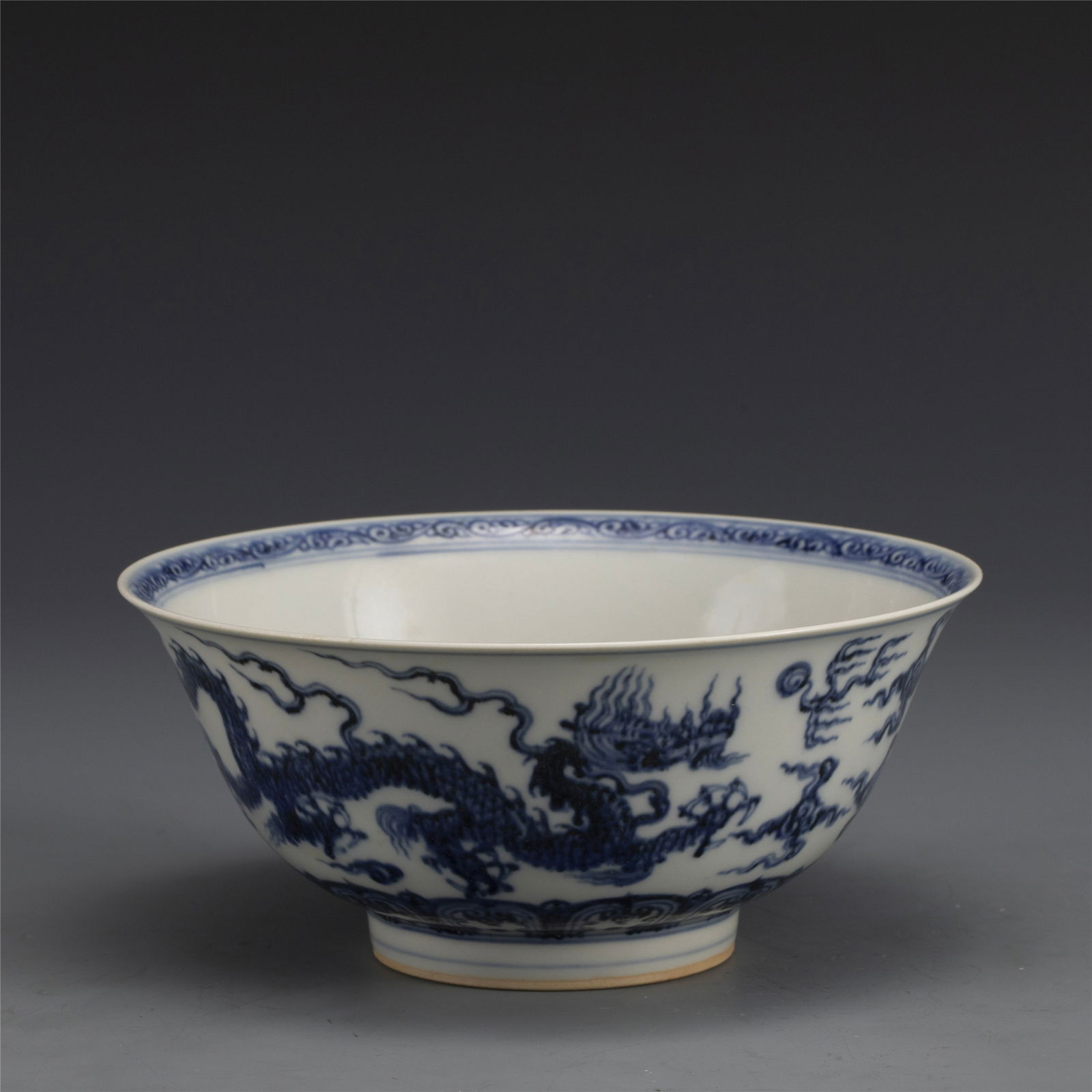 MING XUANDE BLUE & WHITE DRAGON BOWL: Dimensions: Width: 18cm, Height: 7. 8cm. Chinese Ming Dynasty Xuande Blue and White Dragon Porcelain Bowl. The porcelain potted in a shallow, slight deep, round close mouth rim, raised on ring foot ba