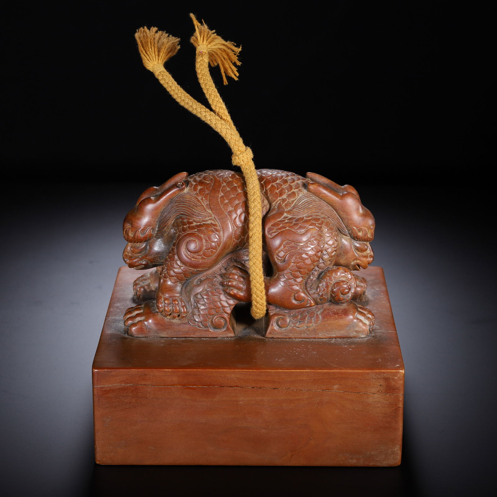 CHINESE SANDALWOOD SEAL: Dimensions: L. 16 cm. W. 15.6 cm. H. 14 cm. Weight 1450 grams. This imposing Chinese seal is carved from dense, fragrant sandalwood, displaying a rich, warm chestnut patina. The top features a powerfu