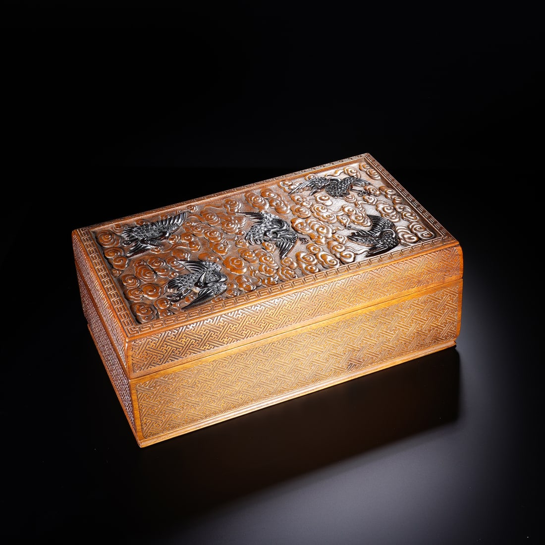 CHINESE BOXWOOD CRANE & CLOUD BOX: Dimensions: 26x15x10 cm. A fine Chinese boxwood rectangular box, the lid carved with five cranes soaring amidst dense swirling clouds, symbolizing longevity and celestial harmony. The sides are decora