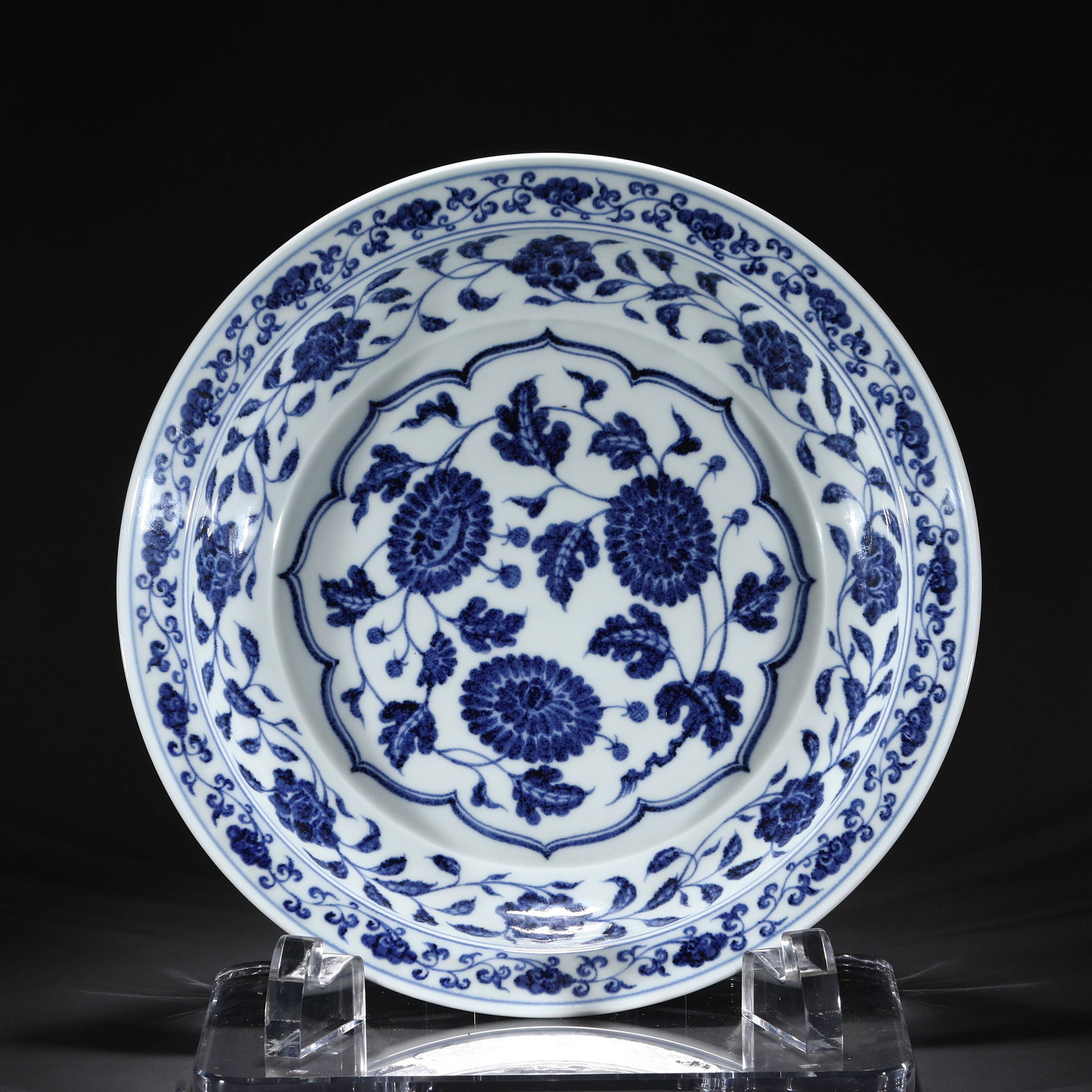 A MING BLUE AND WHITE PORCELAIN DISH: Dimensions: 43.5 cmcm, Diam x 7.5 cm H x Weight 3100 gram. The dish has rounded sides and an inverted rim, and is decorated in the center with chrysanthemum scrolls encircled with peonies scrolls.