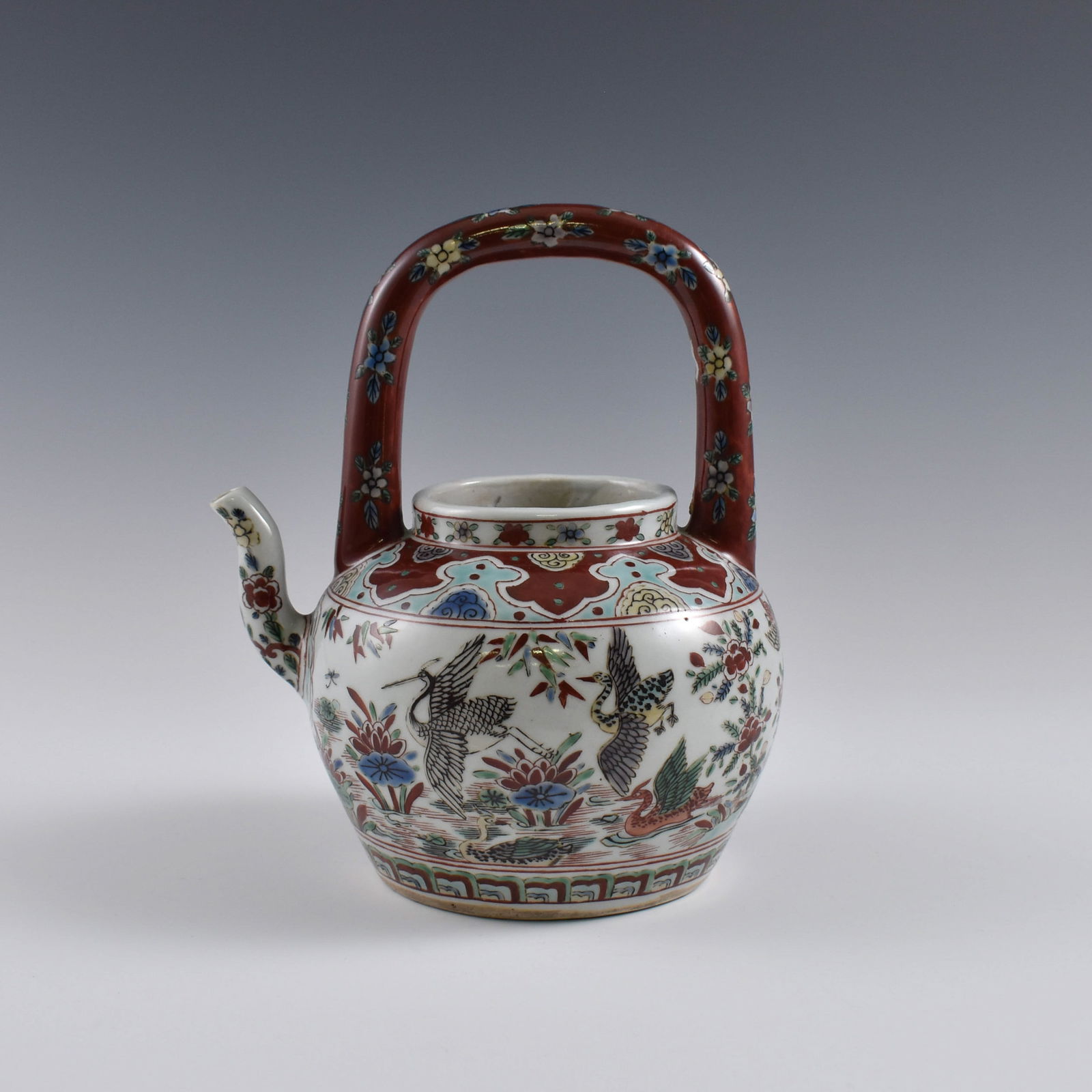 MING WANLI WUCAI CRANES PORCELAIN TEA POT: Dimensions: 8-3/4" H x 7-3/4" W Chinese Ming Dynasty Period, Wucai cranes porcelain tea pot. Potted in tea pot shape, thick and slight tall, cylindrical body, slight heavy on lower belly, gently towar