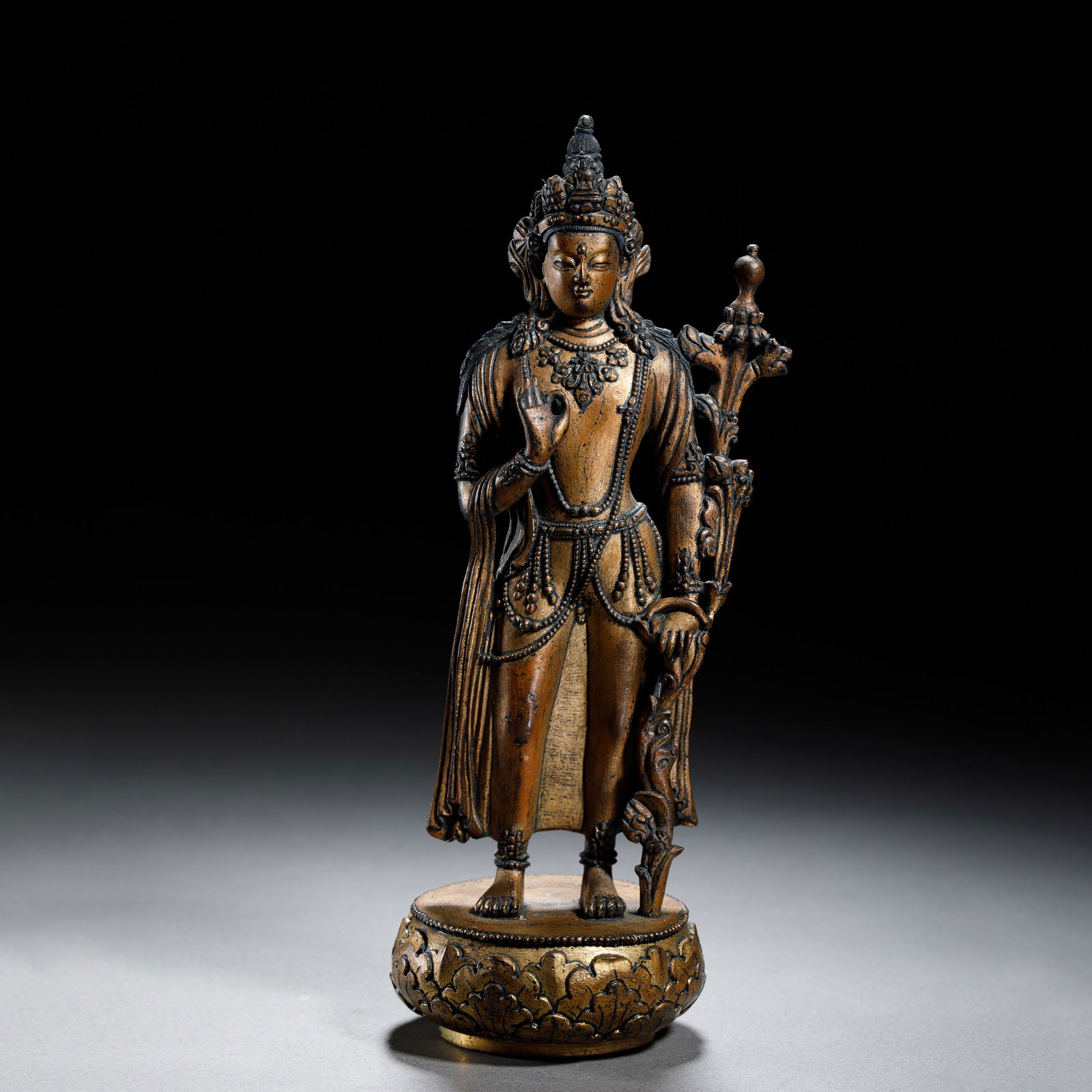 CHINESE GILT-BRONZE STANDING TARA: Dimensions: H. 20.5 cm. W. 7.2 cm. Weight 795 grams. This finely cast Chinese gilt-bronze figure depicts the Standing Tara, the compassionate Buddhist deity. She stands gracefully on a lotus base, ado