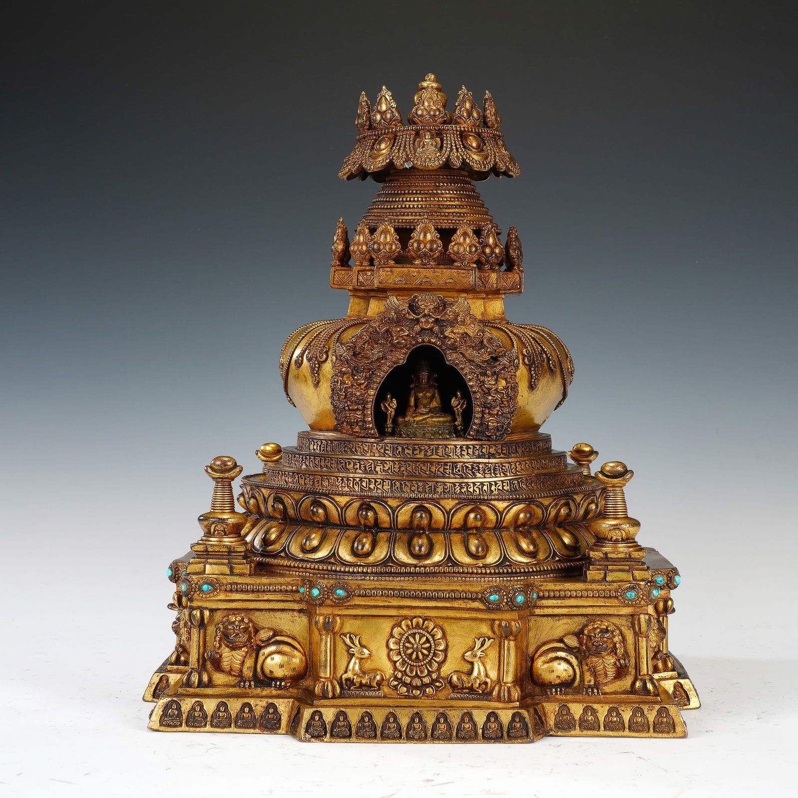 CHINESE GILT BRONZE STUPA: Dimensions: 33x33x39 cm. Weight 15700 grams. This magnificent Chinese gilt bronze stupa is a masterpiece of Buddhist art, constructed in a multi-tiered form. Its base is adorned with animal motifs