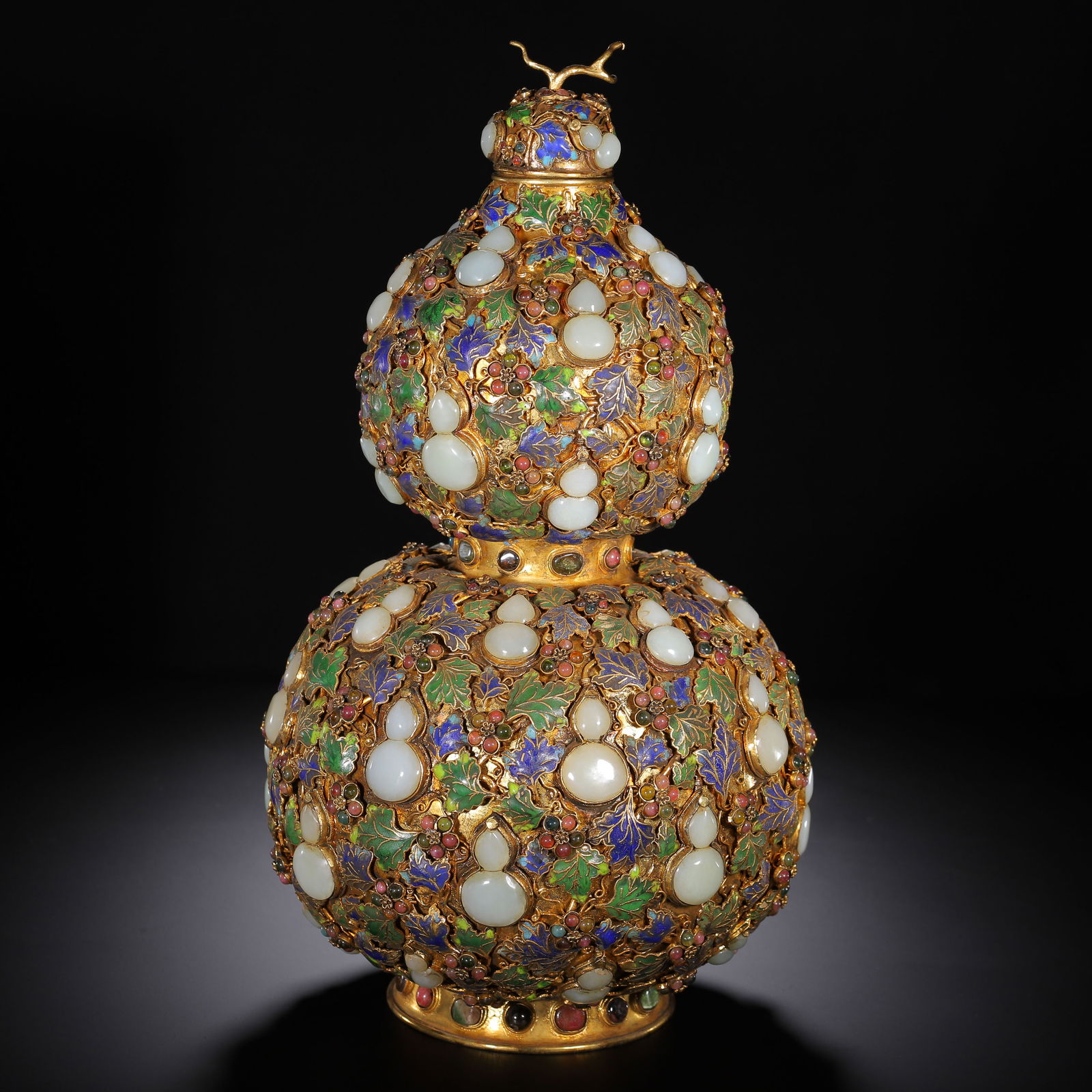 CHINESE GILT-BRONZE JADE-INLAID GOURD VASE: Dimensions: L. 20 cm. W. 20 cm. H. 38 cm. Weight 3850 grams. This magnificent Chinese double-gourd vase is crafted from gilt bronze, its surface densely inlaid with luminous white jade cabochons and v