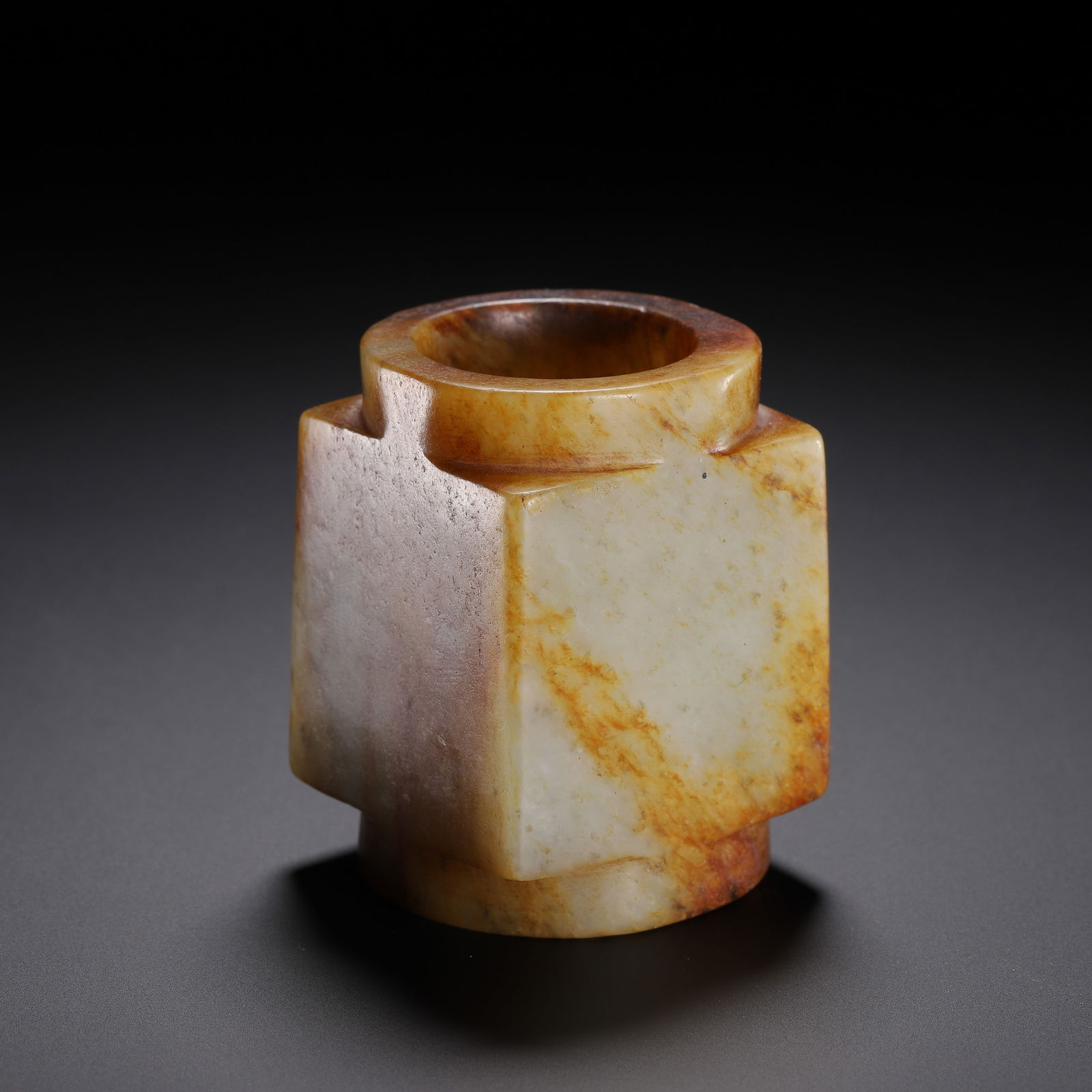 CHINESE JADE CONG: Dimensions: L. 4.5 cm. W. 4.5 cm. H. 6.7 cm. Weight 250 grams. This compact Chinese jade cong is carved from a pale celadon stone with rich, natural russet inclusions that streak its smooth, polished