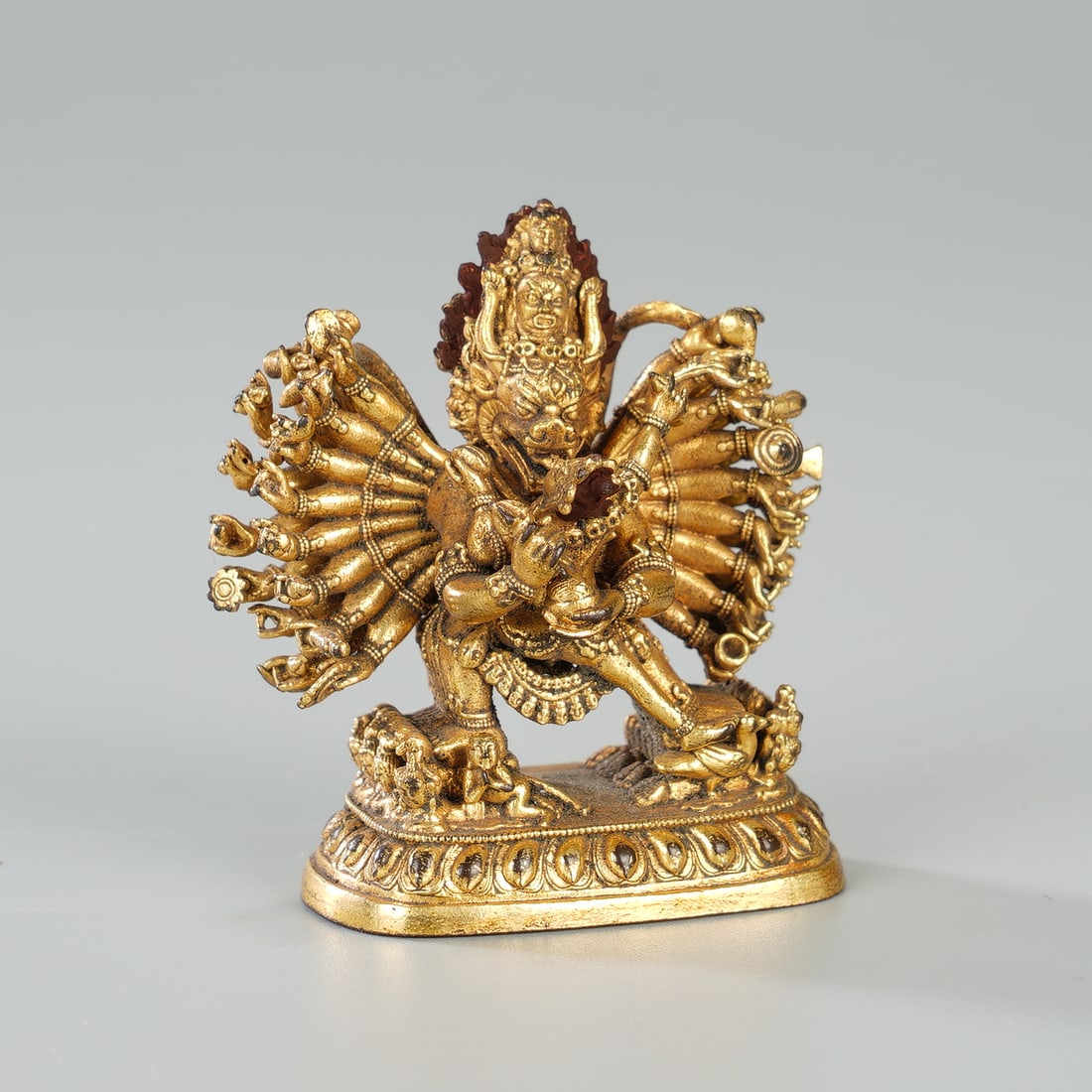 CHINESE GILT BRONZE YAMANTAKA FIGURE: Dimensions: 3.5x1.7x3.9 cm. A finely cast Chinese gilt bronze figure of Yamantaka, the wrathful deity of Tibetan Buddhism. The multi-headed, multi-armed form stands dynamically atop a lotus base, each