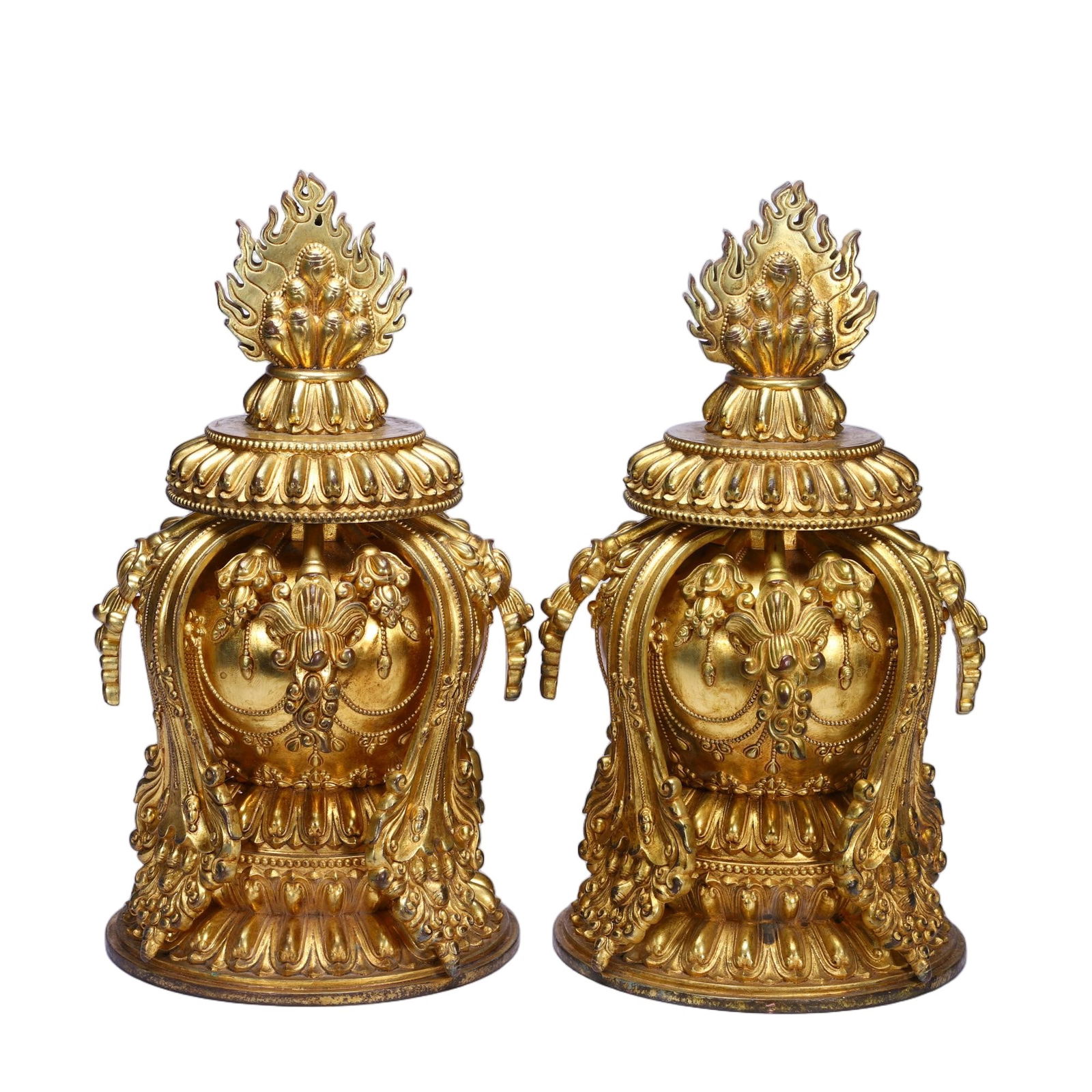 CHINESE GILT BRONZE RELIC STUPA: Dimensions: L. 13 cm. W. 13 cm. H. 24 cm. Weight 4470 grams. This magnificent pair of Chinese gilt bronze relic stupas features a dramatic flame finial atop a tiered lid, which crowns an ornate, bell-