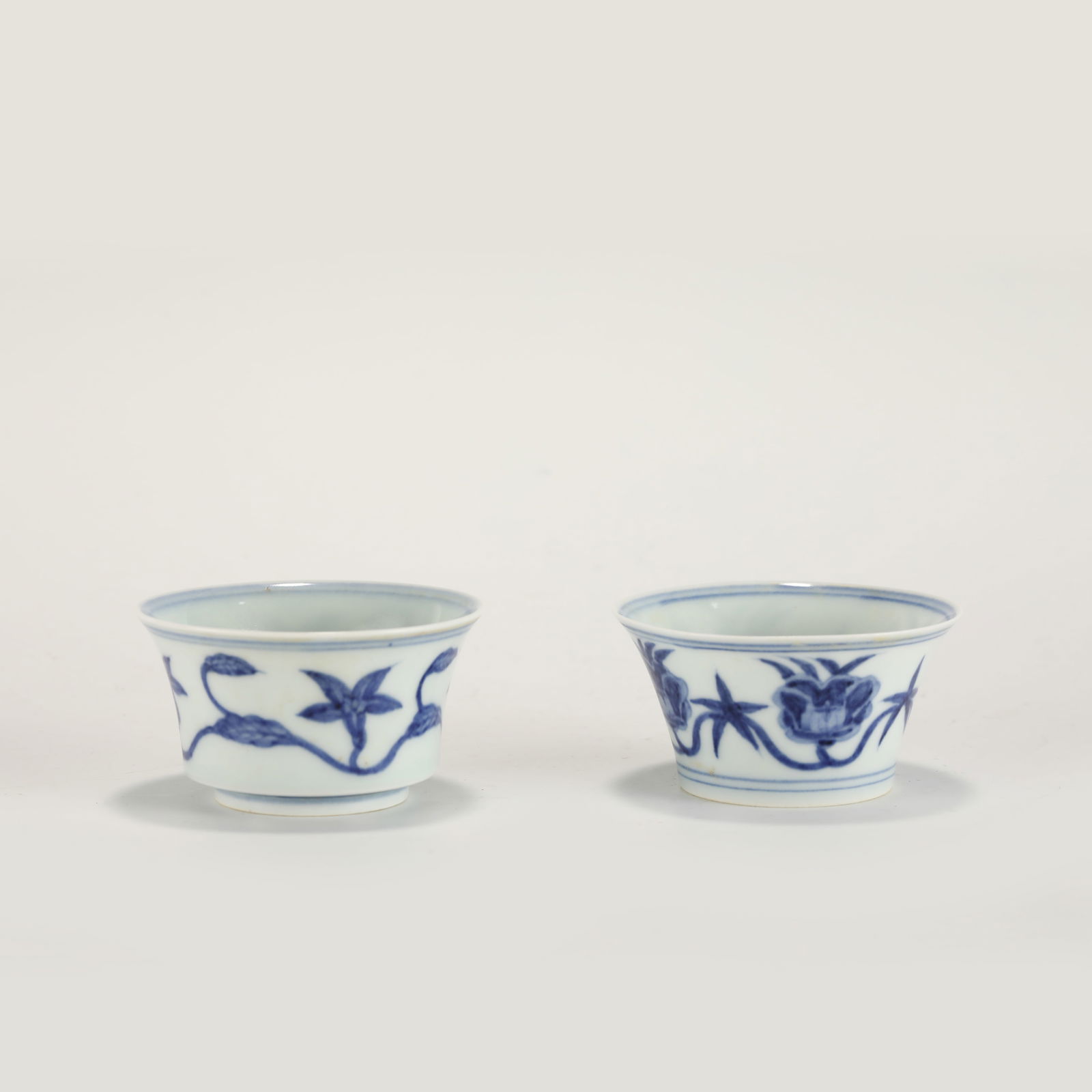 MING CHENGHUA BLUE AND WHITE CUPS: PROVENANCE: From Celina, TX Private Collector. Dimensions: Height: 4.2 cm,cm, Diameter: 7.9 cm Pair of Chinese Ming Dynasty Chenghua Blue and White Flower Porcelain Cups. The porcelain potted with a