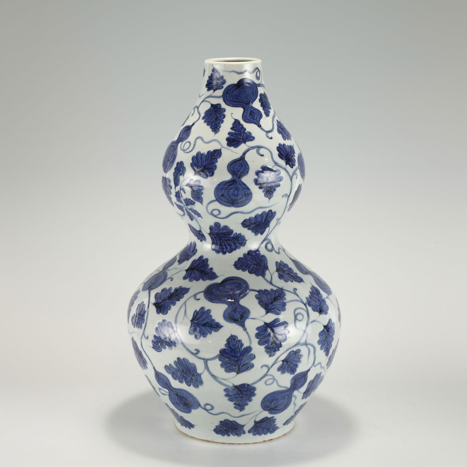 YUAN BLUE AND WHITE GOURD BOTTLE: PROVENANCE: From Celina, TX Private Collector. Dimensions: Height: 52 cm,cm, Diameter: 30.5 cm Chinese Yuan Dynasty Blue and White Porcelain Gourd Bottle. Potted in a shape of double gourd resemblanc