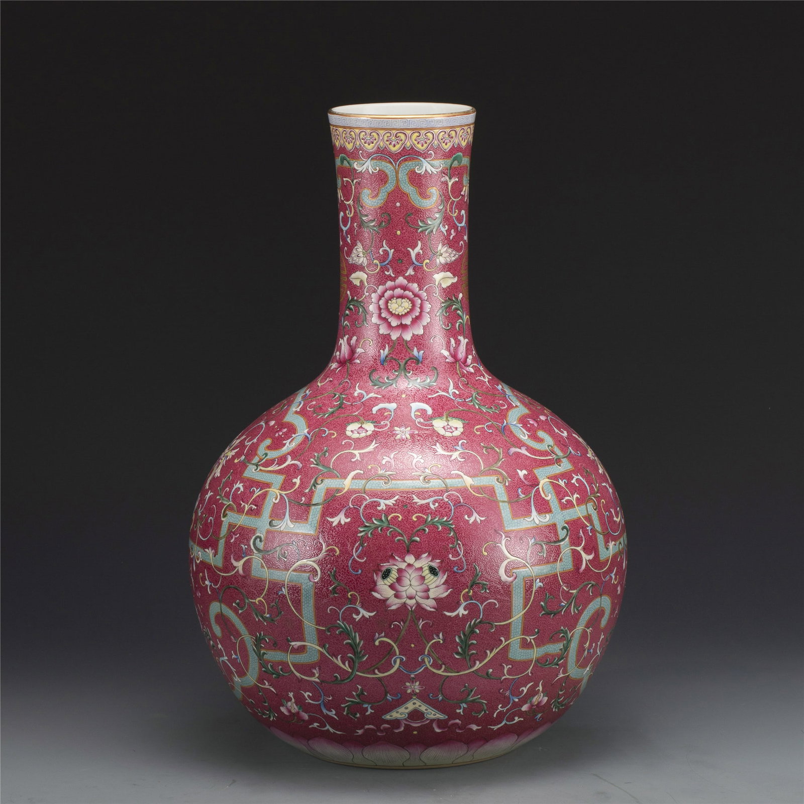 QIANLONG FAMILLE ROSE RUBY RED GROUND VASE: Dimensions: Width: 33.5cm, Height: 48.5cm. Chinese Qing Dynasty QianLong Famille Rose Lotus Ruby Red Ground Porcelain Celestial Bottle Vase. Potted in celestial bottle shape, thick and tall, globular 