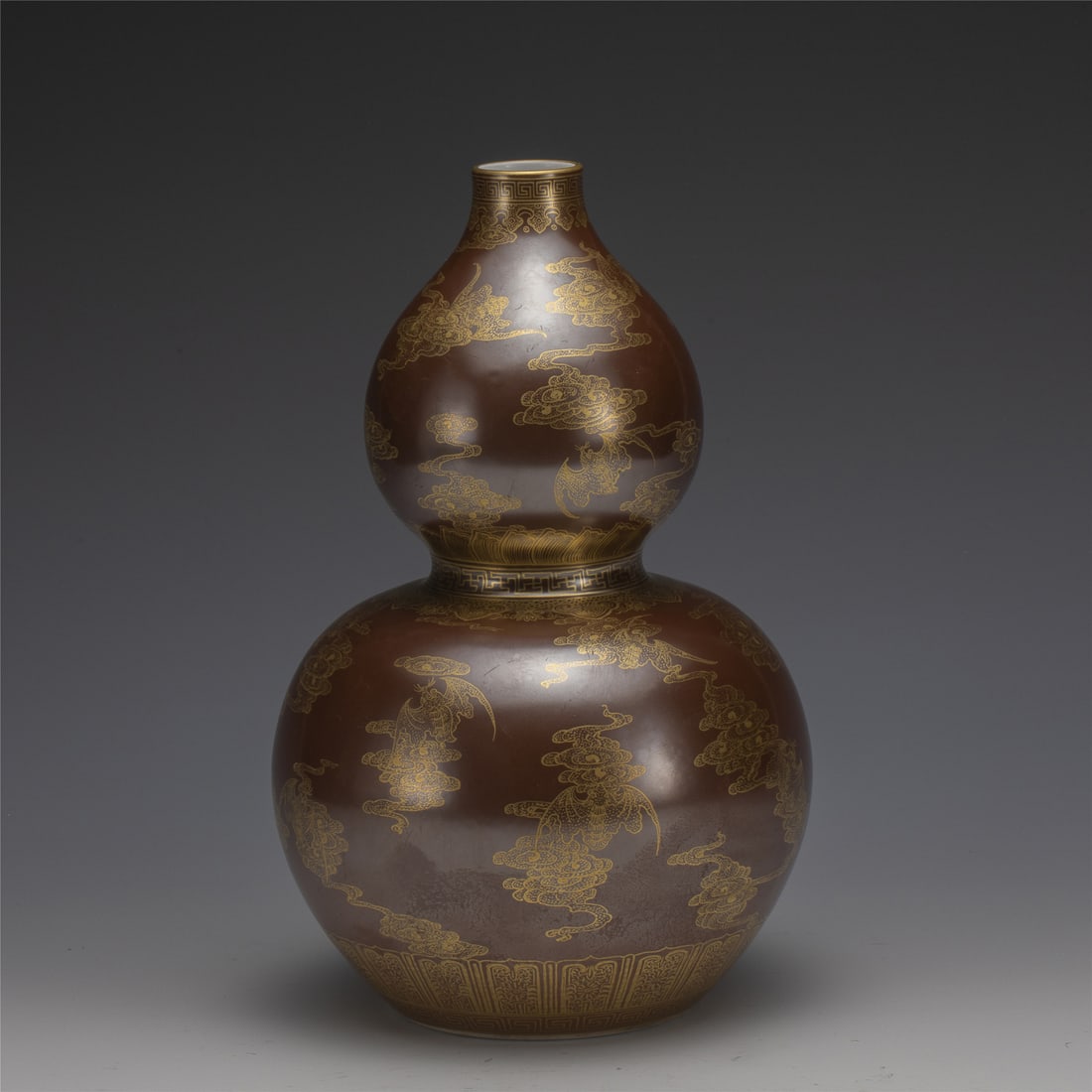 QIANLONG GILT FU BAT MOTIF GOURD BOTTLE: Measurements: Length: 17 cm, Height: 26.8 cm Chinese Qing Dynasty Qianlong Fu Bat Porcelain Gourd Bottle. Potted in a shape of double gourd resemblance, with two bulbous bellies conjoined together, bu