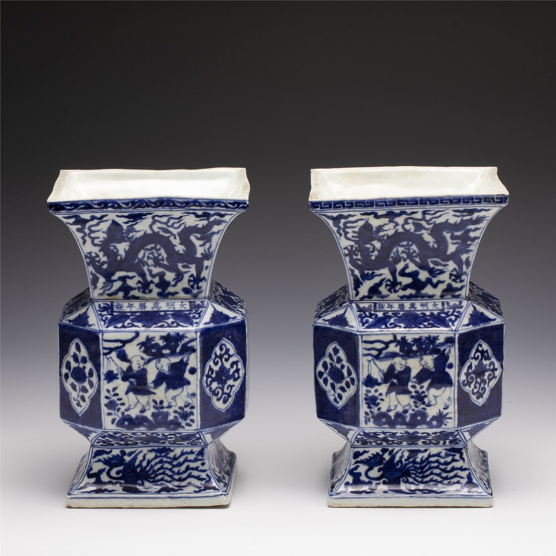 PAIR MING WANLI BLUE & WHITE GOBLETS: Measurements: Length: 15.8 cm, Width: 15.8 cm, Height: 25.7 cm Pair of Chinese Ming Dynasty Wanli Blue and White Porcelain Goblet Vases. Potted in a traditional Gu shape. The beaker having baluster sh