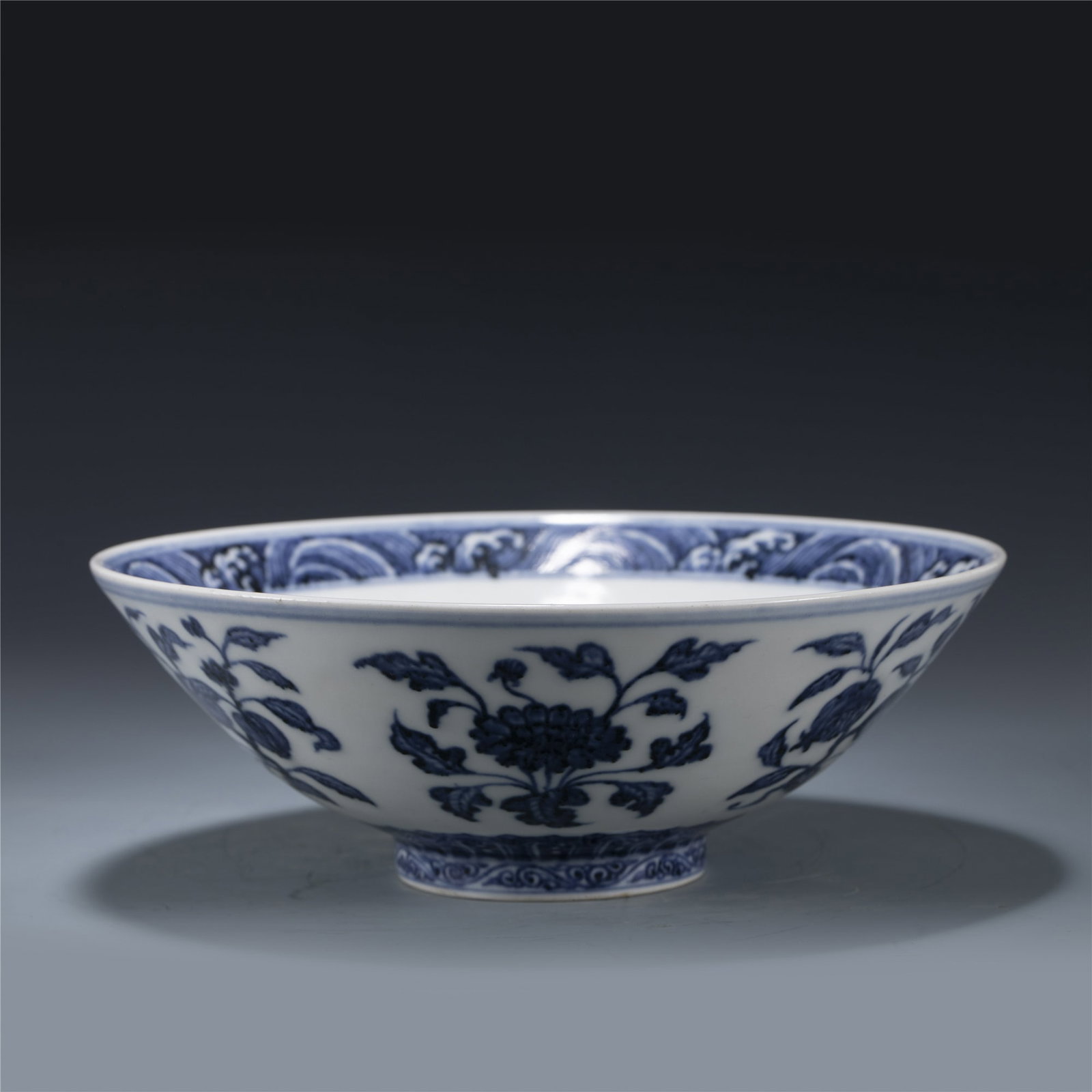 MING XUANDE BLUE AND WHITE BOWL: Dimensions: Length: 22.5 cm, Width: 22.5 cm, Height: 7.8 cm Chinese Ming Dynasty Xuande Blue and White Porcelain Bowl. The Bowl has a shallow body, slight deep, thick and bulbous body, with angled cav