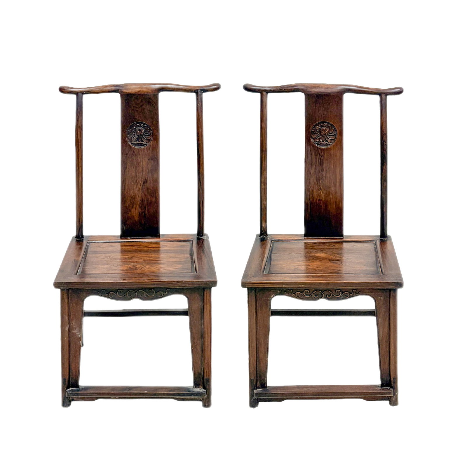 PAIR OF CHINESE HUANGHUALI SIDE CHAIRS: Dimensions: 109.22 cm H x 52.07 cm W x 44.45 cm D A finely matched pair of Chinese huanghuali Officer Hat side chairs, each featuring a gently curved crest rail, carved back splat with a floral medall
