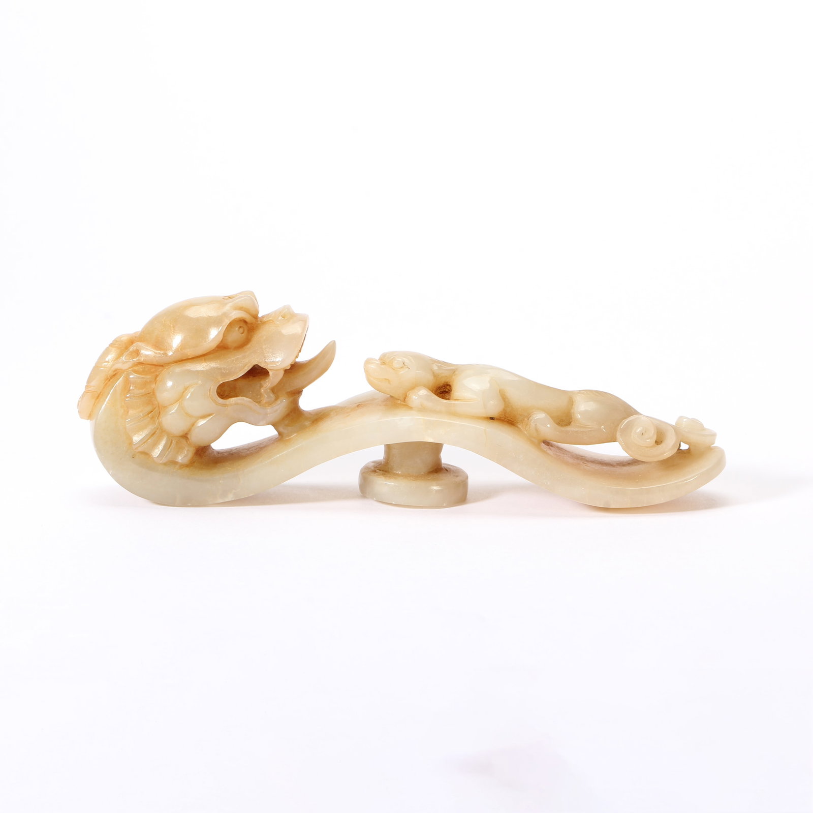 A CHINESE ARCHAIC DRAGON JADE BELT HOOK: Weighing 120 grams, this exquisite belt hook measures 12.5 cm in length, 3 cm in width and 4 cm in height. Carved from warm creamy-toned nephrite with soft natural patination, the piece features a sha