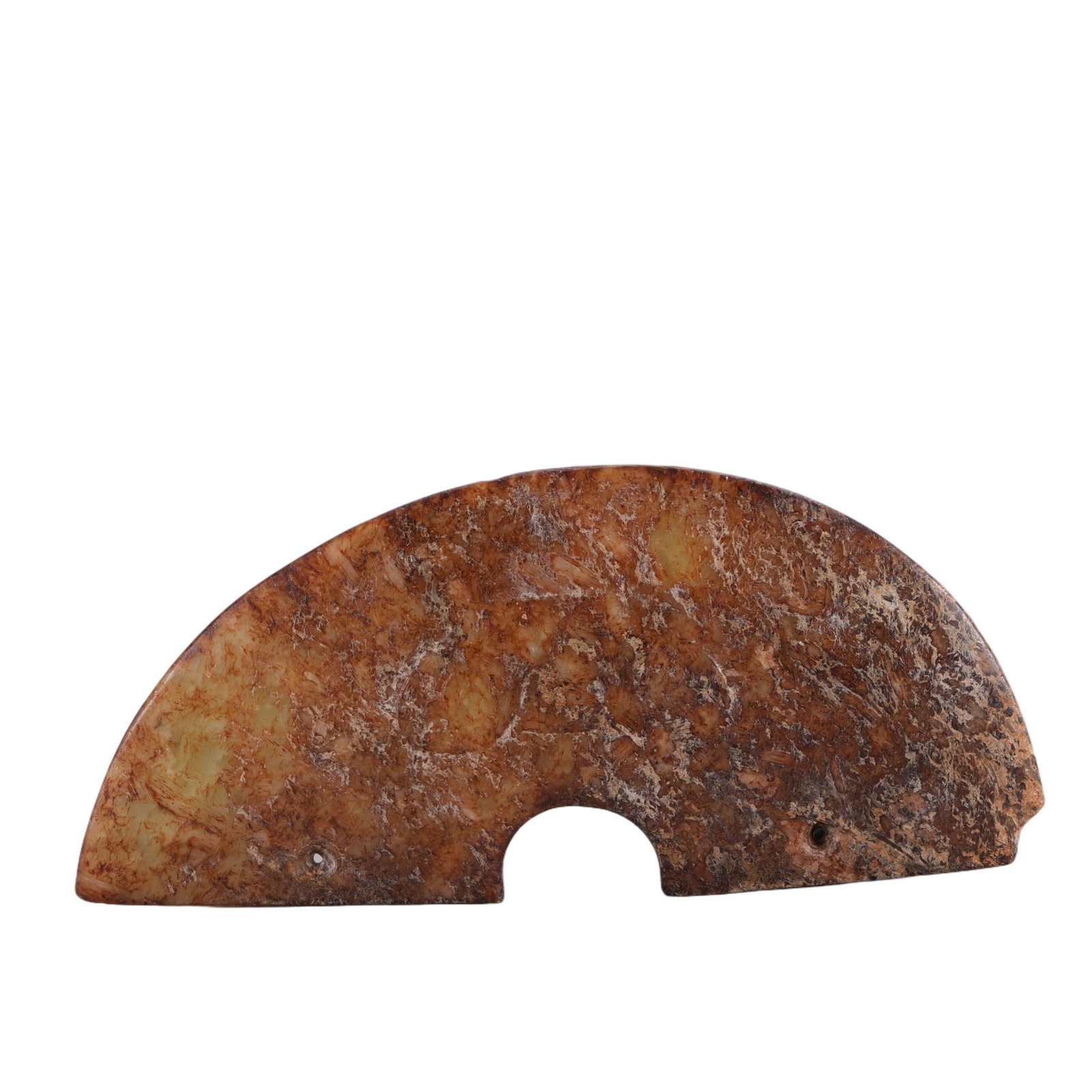 A CHINESE ARCHAIC JADE HUANG PENDANT: This semi-circular ritual jade huang is crafted from nephrite heavily permeated with deep russet and earthy calcified patina, revealing faint celadon stone core beneath weathered encrustations. A neat