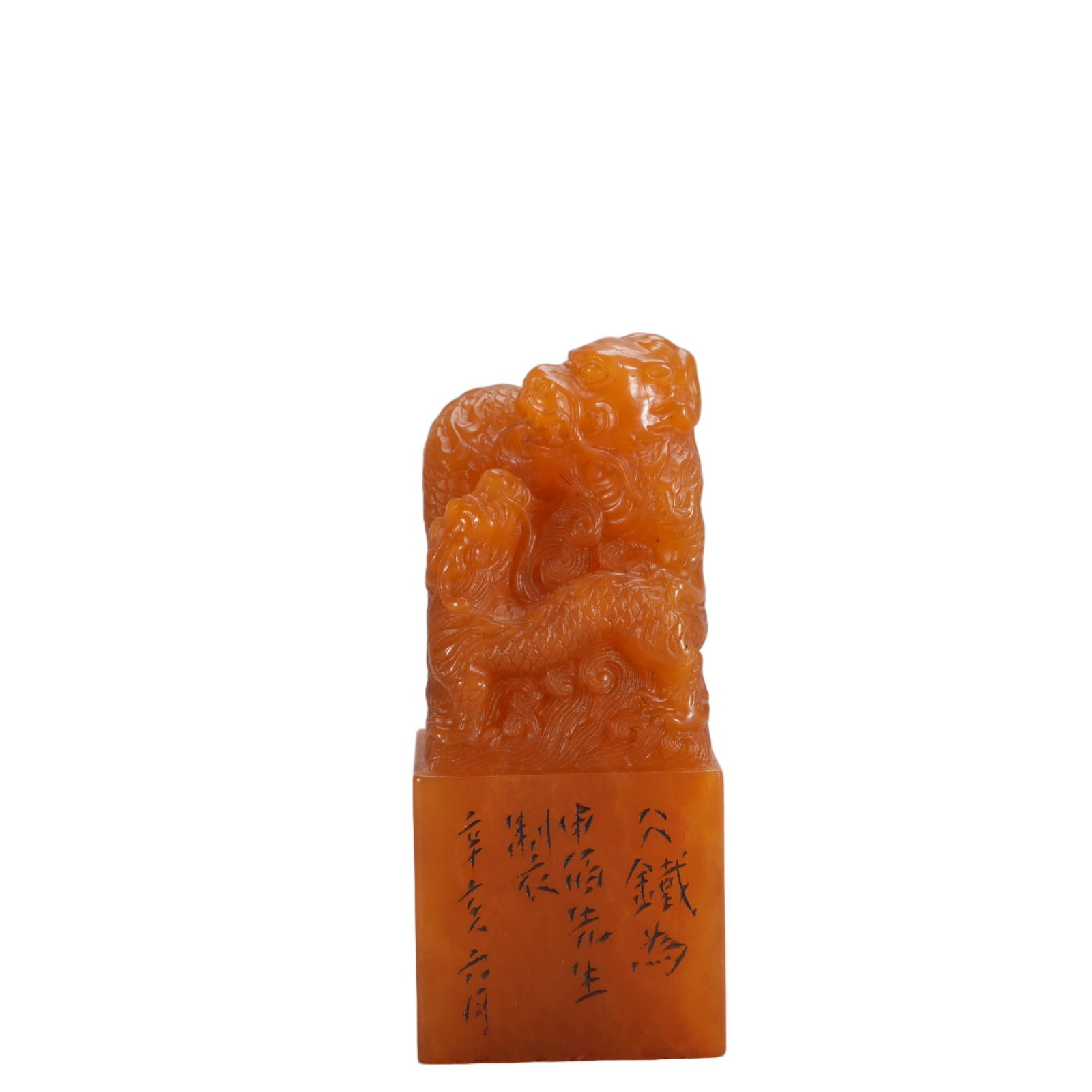 A CHINESE TIANHUANG QILIN CARVED SEAL: This square seal is hewn from rich honey-toned Tianhuang stone prized by Chinese literati. Its finial features a dynamic relief carving of paired qilin beasts twisting amid rolling cloud patterns, wit