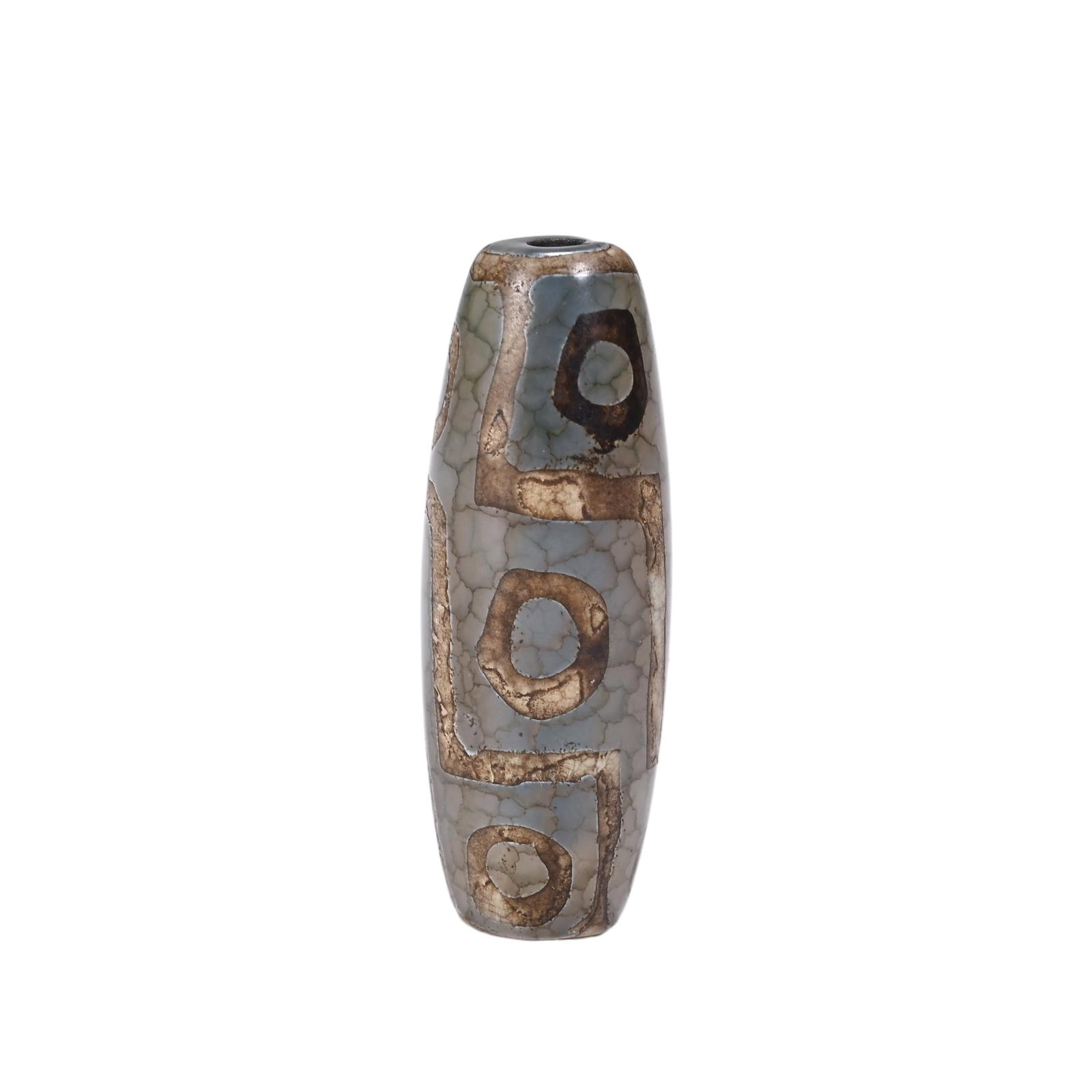 A CHINESE THREE EYE DZI BEAD: Measuring 4.1 cm in length, this barrel-shaped dzi bead displays characteristic aged crackled glaze across its pale grey agate foundation. Three clearly delineated eye emblems are outlined by warm tan
