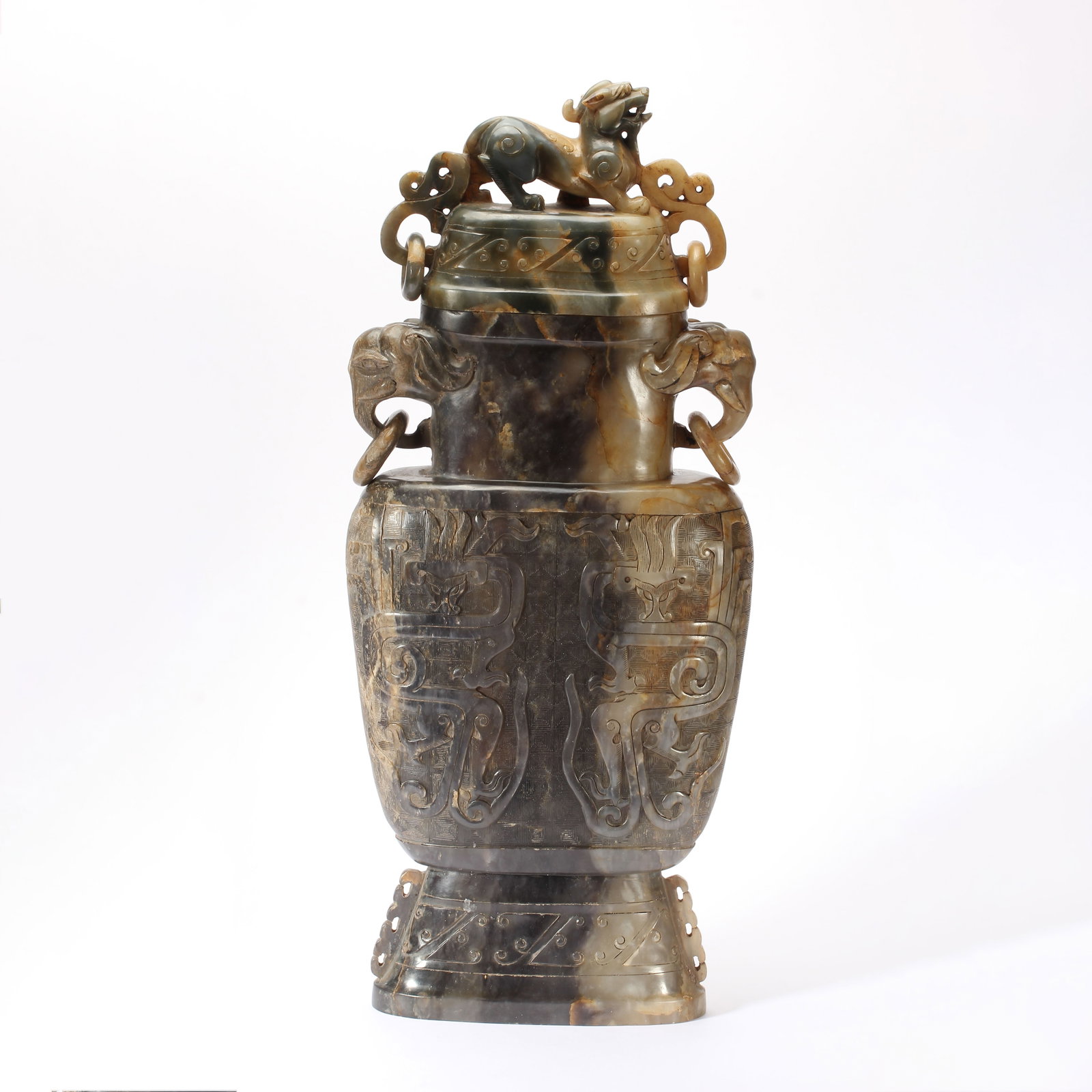 A CHINESE ARCHAIC LIDDED JADE VASE: Weighing 5140 grams, this stately antique jade vase has dimensions of 21 cm in length, 8 cm in width and 49 cm in height. The stone displays captivating mottled patterning blending warm amber streaks 