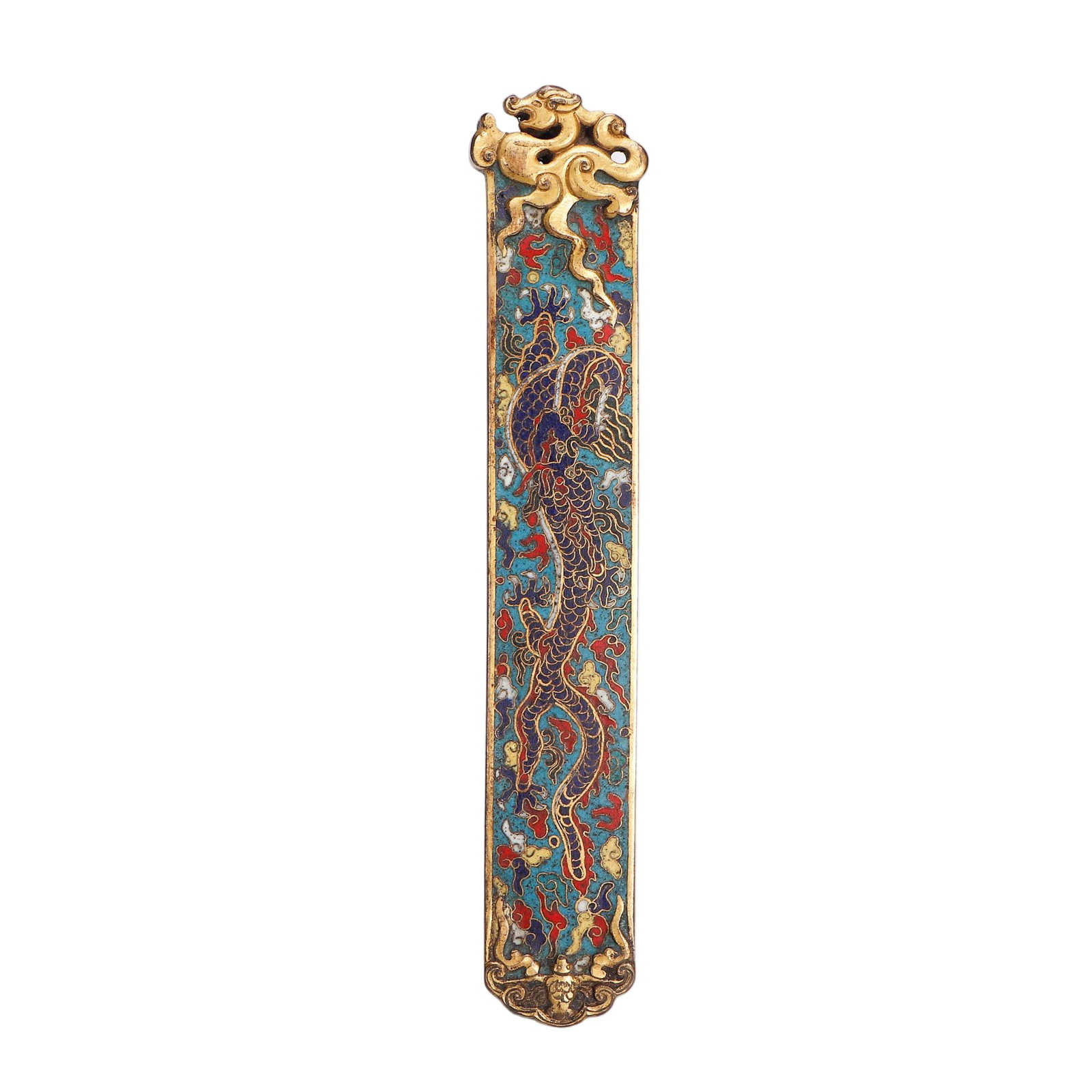 A CHINESE GILT CLOISONNE DRAGON PAPERWEIGHT: Stretching 20 cm in length, this slender rectangular paperweight is expertly fashioned from gilded copper with elaborate cloisonne detailing. An ornate sculpted gilt mythical-beast finial crowns the u