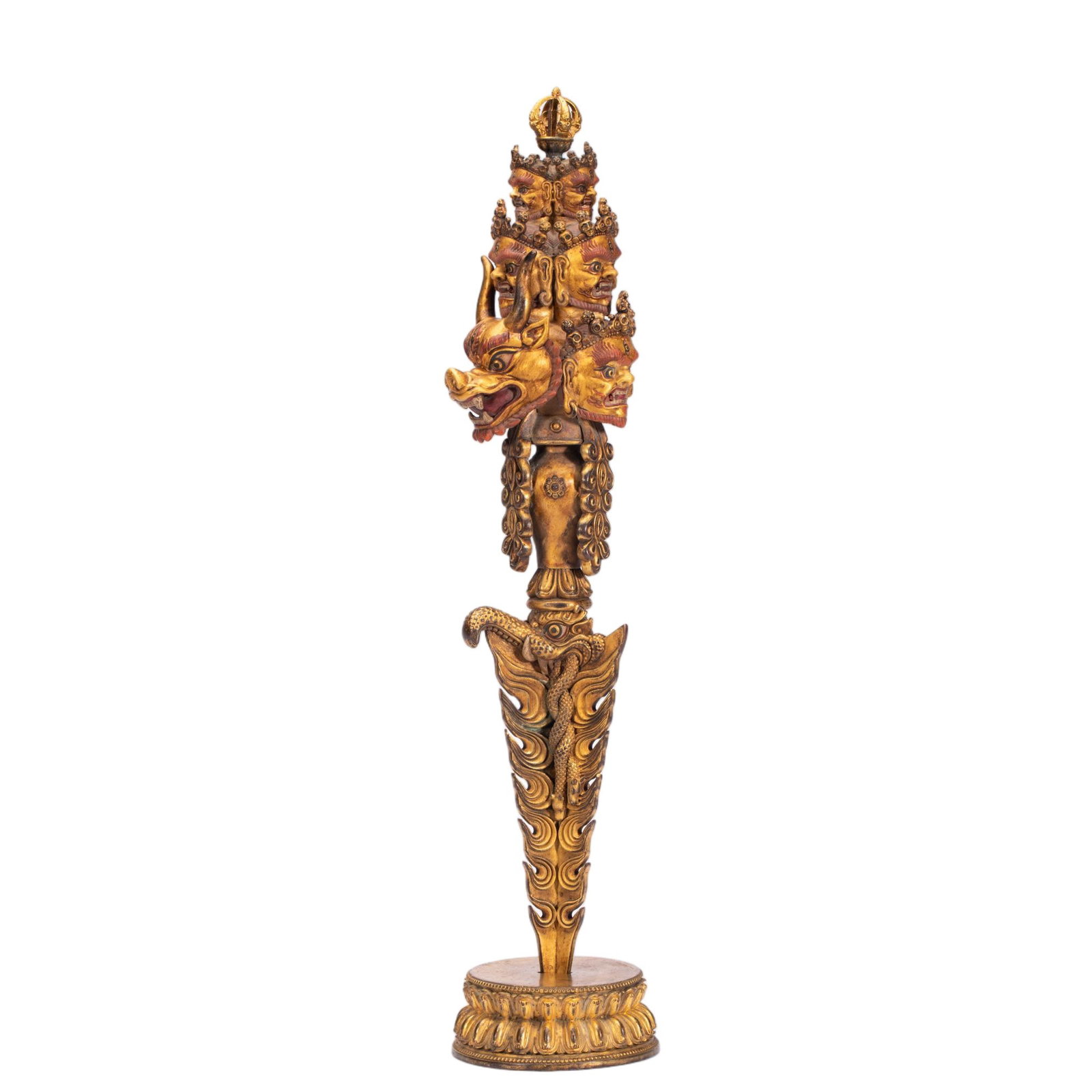 A CHINESE GILT BRONZE RITUAL DAGGER: This elaborate Tibetan Buddhist ritual implement weighs 860 grams, measuring 7 cm in length, 7 cm in width and standing 32 cm tall. Stacked tiers of intricately sculpted wrathful deity heads culminate