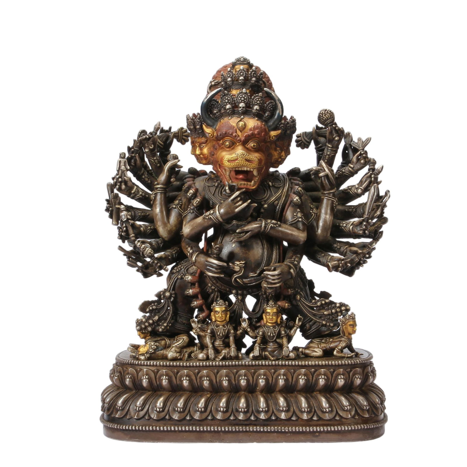 A CHINESE PARCEL GILT SILVER WRATHFUL BUDDHA: Weighing 9380 grams, this formidable sculptural piece measures 24 cm long, 14 cm wide and 33 cm in height. Crafted primarily from silver with selective gilt highlights, the multi-armed guardian deity 