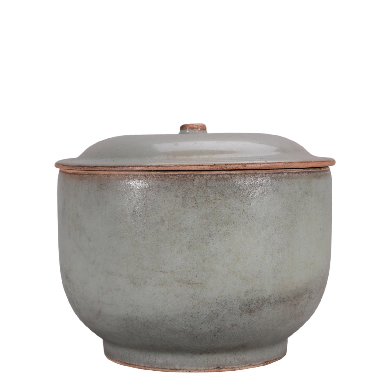 A CHINESE LONGQUAN PINKISH CELADON COVERED BOWL: This well-proportioned lidded vessel features a stout cylindrical body rising to a broad flat rim, matched with a domed cover topped by a small circular knob. The entire exterior is enveloped in thick