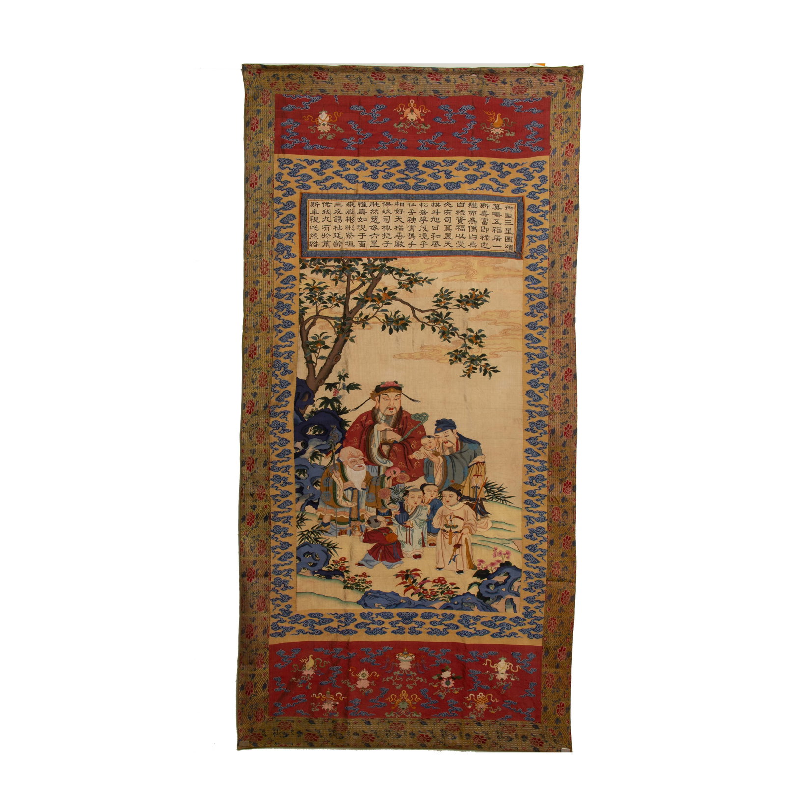 A CHINESE KESI THREE STAR LONGEVITY TAPESTRY: Measuring 280 cm in length and 136 cm in width, this large-scale kesi tapestry depicts the three auspicious stellar deities of Fortune, Prosperity and Longevity gathered beneath a leafy tree, accompan