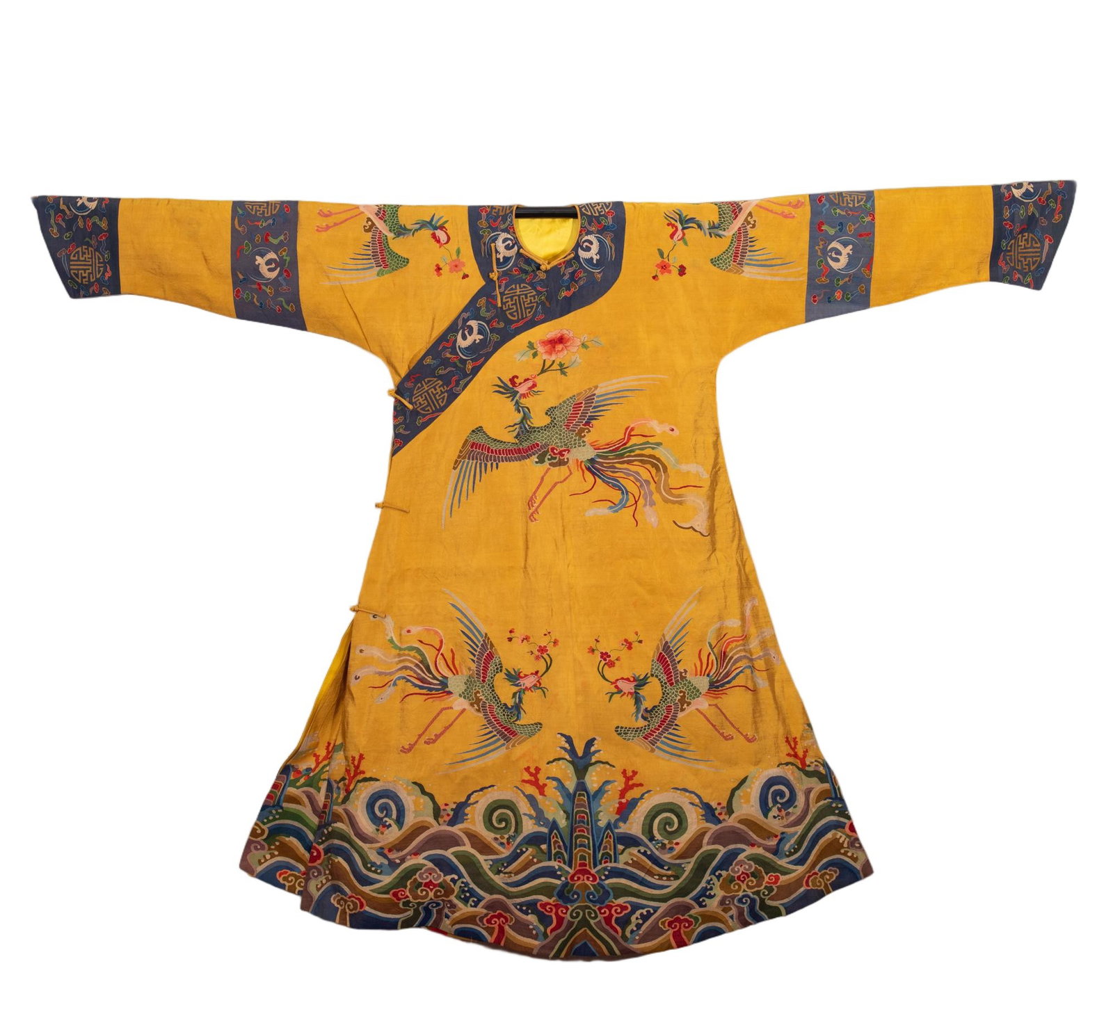 A CHINESE KESI WOVEN PHOENIX ROBE: Spanning 191 cm in length and 138 cm in width, this exquisite court robe is woven with refined kesi tapestry techniques against a luminous imperial yellow silk ground. Graceful phoenixes with vibrantl