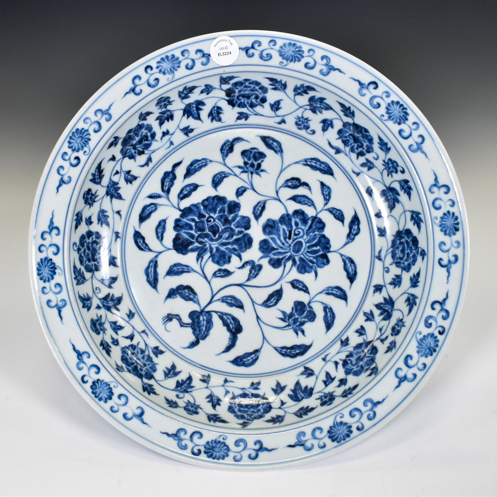 BLUE & WHITE WRAPPED FLORAL PLATE: Dimensions: 13" Diameter. A Superb and Large Chinese Blue and White Porcelain Charger, Ming-Style Floral Scroll DesignA finely painted large blue and white porcelain charger, decorated in rich undergl
