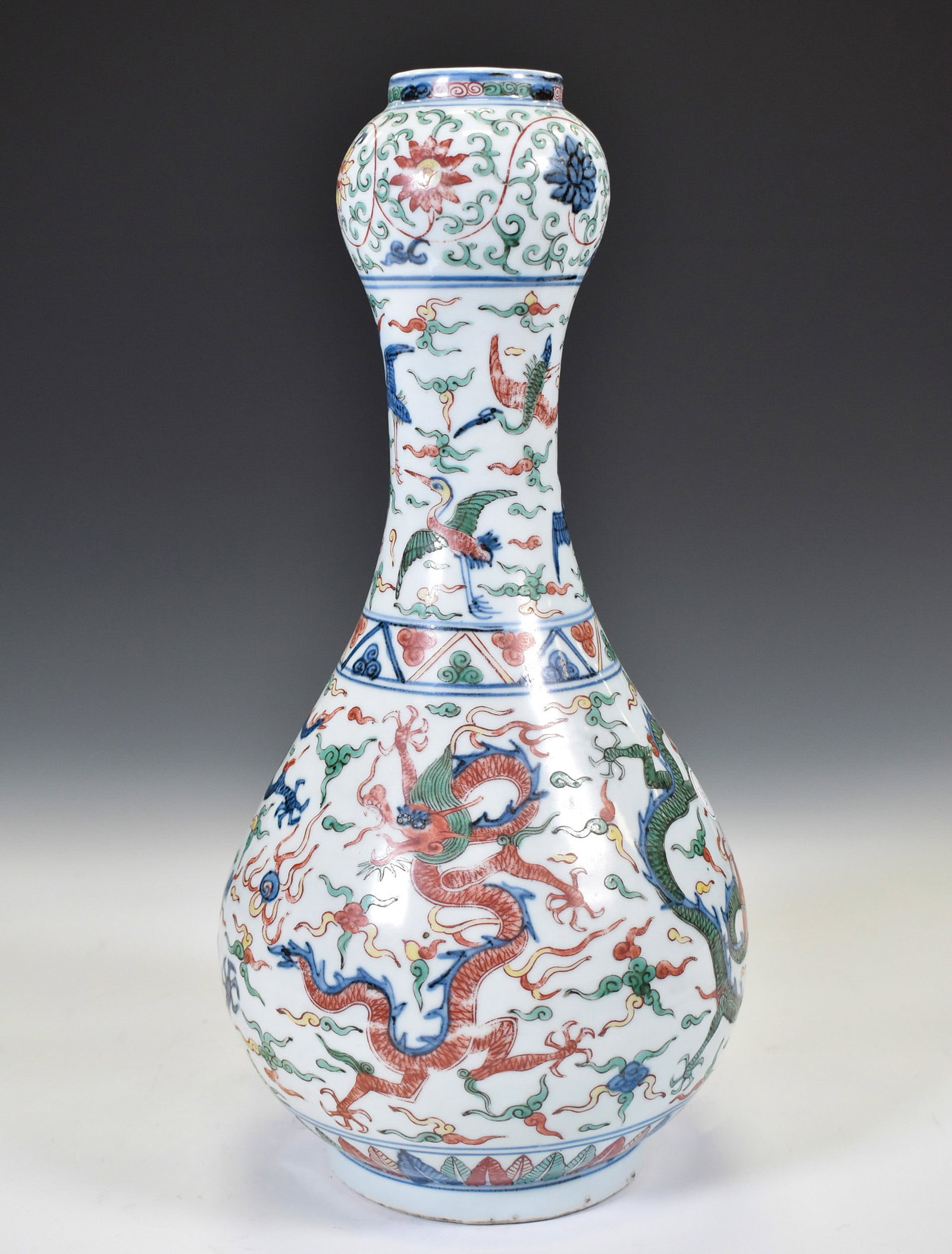 WUVAI DRAGON GARLIC HEAD VASE: Dimensions: 15"H x 5"W Chinese Ming Dynasty Period, Wucai dragon motif porcelain garlic vase. Potted in garlic bottle vase, bulbous lower belly, thick, with rounded shoulder, long cylindrical neck, wi