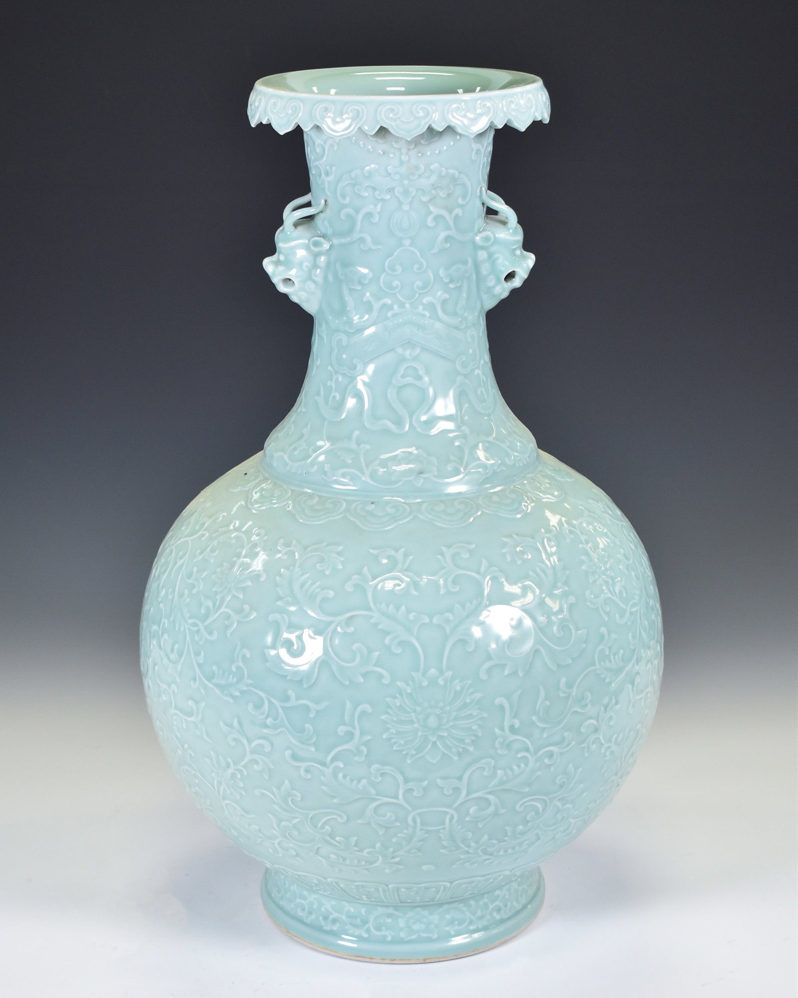 CHINESE DOUQING CELADON PORCELAIN VASE: Dimensions: 20.5"H x 12"W Chinese porcelain carving douqing glazed sgrafitto begonia vase. Bears Qianlong mark on base.