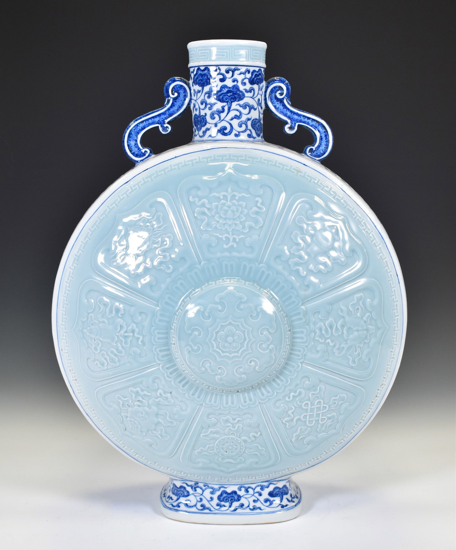 BLUE & WHITE DOUQING GLAZED MOON VASE: Dimensions: 19.5"H x 13"W Chinese Qing Dynasty QianLong DouQing and Blue and White Bajixiang Porcelain Moon Vase On Carved Hardwood Stand. Potted in moon vase, thick and tall, with bulbous lower regio