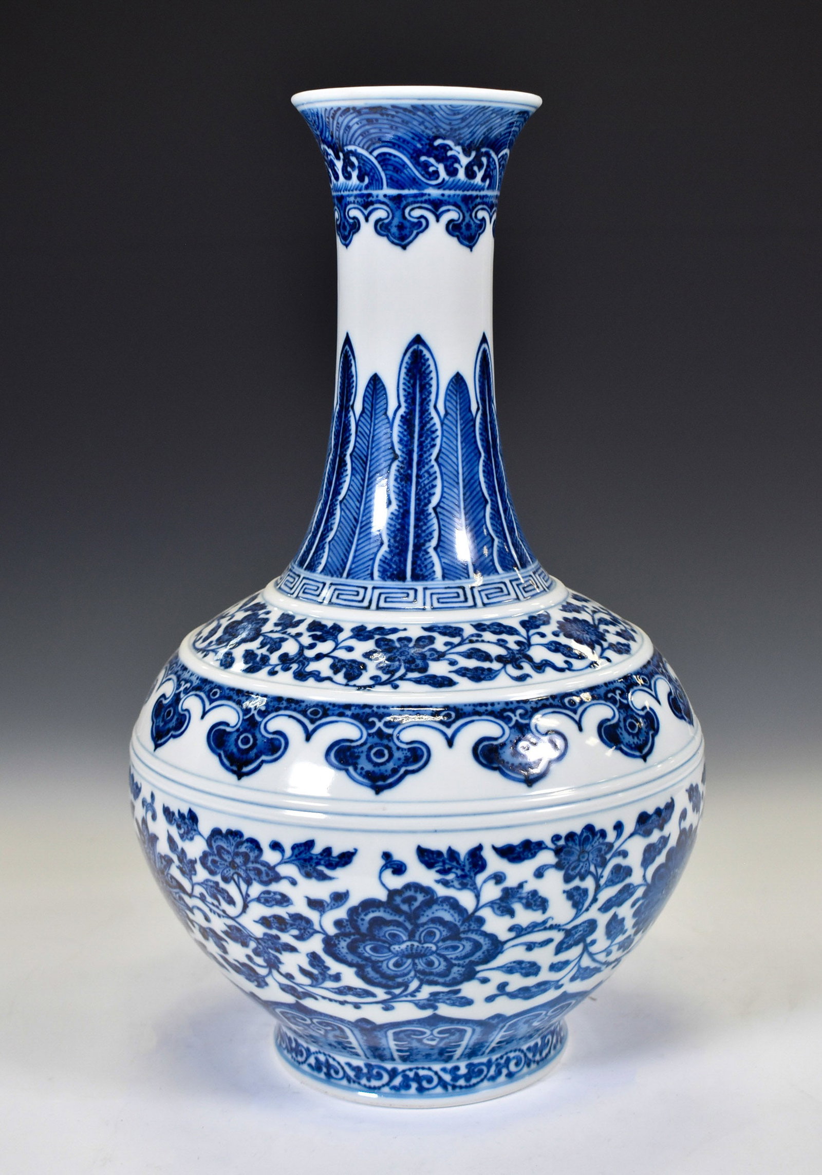 QIANLONG BLUE & WHITE WRAPPED FLORAL REWARD VASE: Dimensions: 12"H x 7"W Chinese Qing Dynasty Qianlong Blue and White Porcelain Jade Pot Spring Vase. This vase has a Chinese traditional YuHuChun shape vessel, the pear shaped bottle, flaring mouth, a 