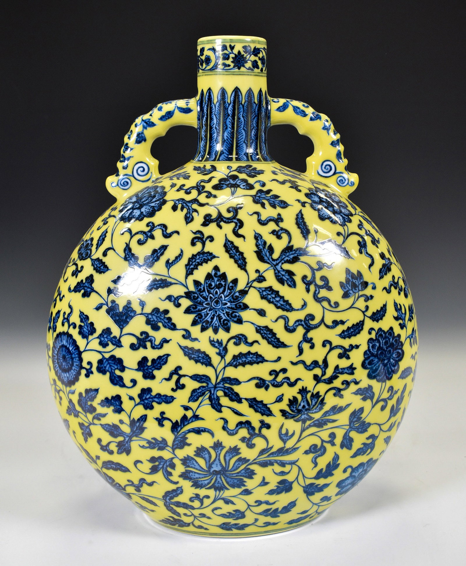 YONGZHENG YELLOW & BLUE WRAPPED FLORAL MOON VASE: Dimensions: 15"H x 12"W Chinese Qing Dynasty Period, Yongzheng Yellow ground blue and white moon holding bottle. The porcelain potted in moon vase, thick and tall, globular moon belly, short neck, rou