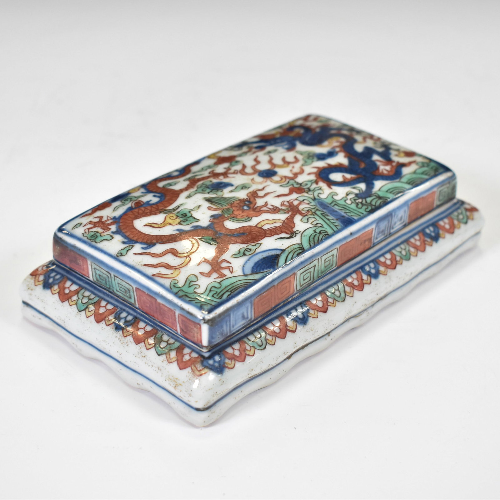 WANLI WUCAI DRAGON PORCELAIN BOX: Dimensions: 7"L x 4"H x 1.5"W Chinese Ming Dynasty porcelain Wucai dragon porcelain ink box in a rectangular deep vessel form with key frets wrapping around the center. The exterior wrapped in Wucai f