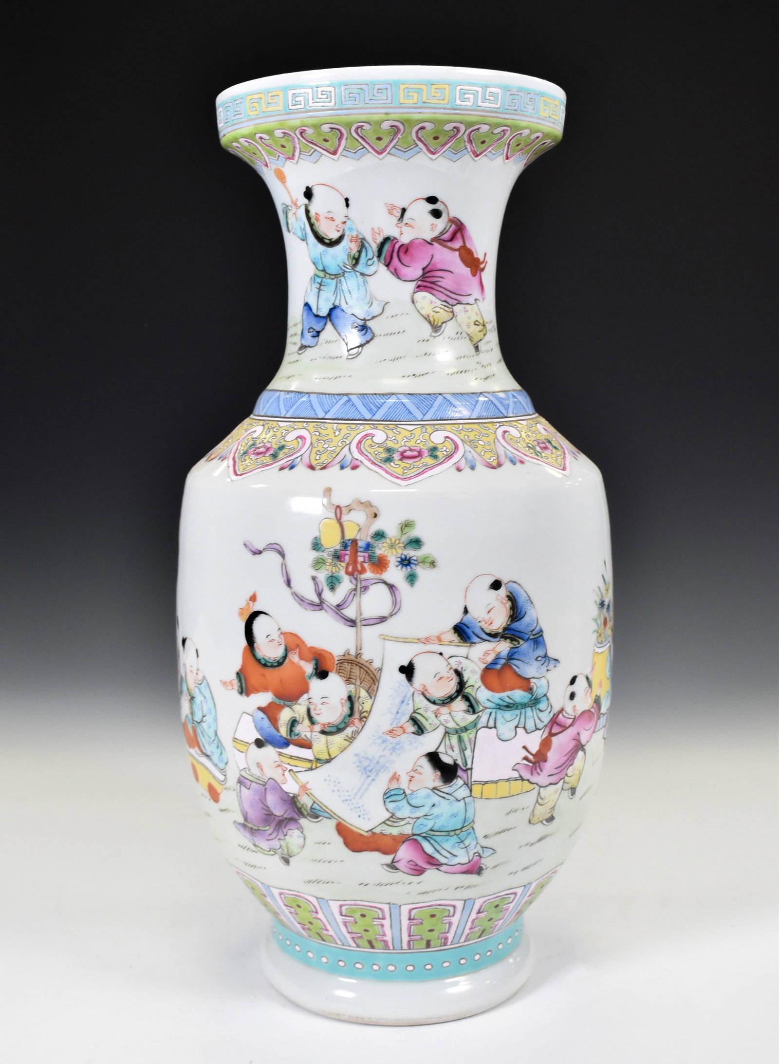 QIANLONG FAMILLE ROSE IMMORTALS FIGURES VASE: Chinese porcelain vase potted with an ovoid body, raised on a splayed foot base, tapered shoulder toward waisted prominent neck leading to flaring banded rim. The exterior decorated in vivid famille r