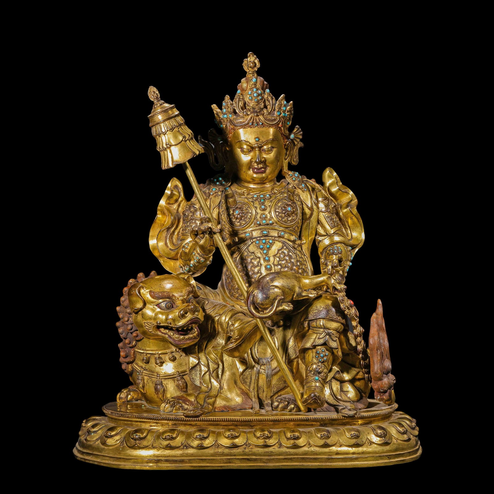 A CHINESE GILT BRONZE VAISHRAVANA STATUE: Measuring 56 cm in length, 32 cm in width and 65 cm in height, this substantial gilt-bronze sculpture weighs 27800 grams. Vaishravana sits regally atop a snarling guardian lion, grasping his signature