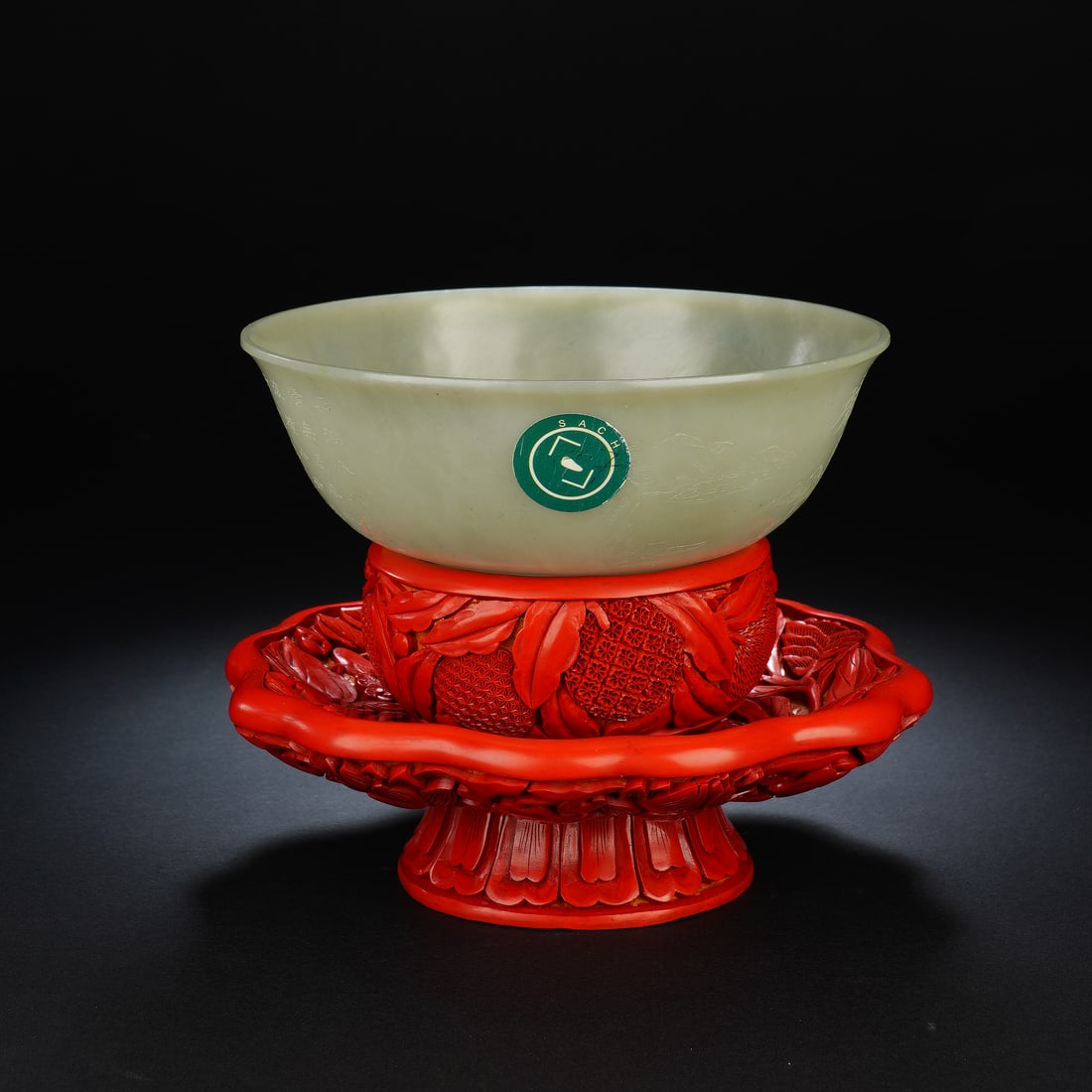 A CHINESE INSCRIBED JADE BOWL WITH CARVED LACQUER STAND: Measuring 15 x 5.5 cm across the jade bowl with an overall standing height of 13 cm, the set weighs 165 grams. Fashioned from fine pale Hotan white jade, the bowl has gently flared rims, sleek curved 