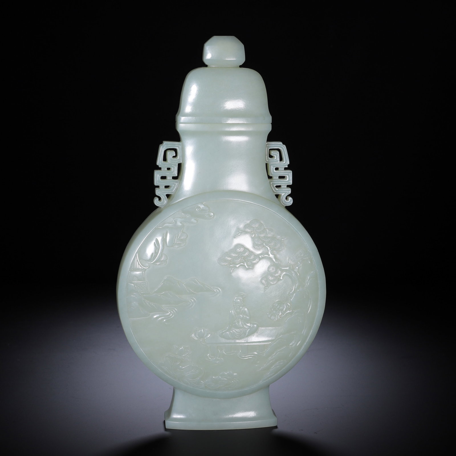 A CHINESE HETIAN JADE VASE: Fashioned from fine pale Hetian jade with a silky lustrous polish, this moon-flask vessel comes with a matching fitted lid topped by a compact knob. Symmetrical fret-patterned openwork handles adorn t