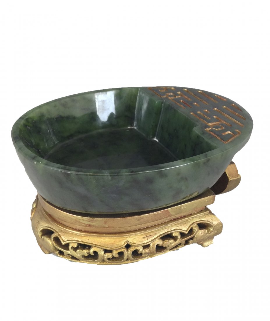 Chinese Carved Spinach Green Jade Brush Washer with: China, Smoothly Carved of Horse shoe shape Brush Washer, deep green lustrous surface jade. Presented on open carved gilt hardwood. Mark on Base, 4 Carved Characters, QiaLong Reign Period and of Period