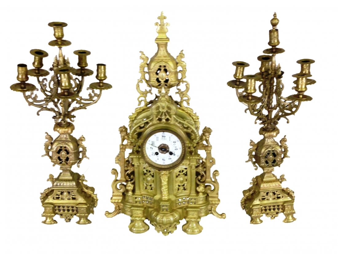 19th c. Louis XV style marquetry inlaid clock: Late 19th century French gilt bronze garniture set consisting of a clock and pair of 6-light candelabra, the clock with a pierced cube flanked by fully formed gryphon term figures surmounting a centra