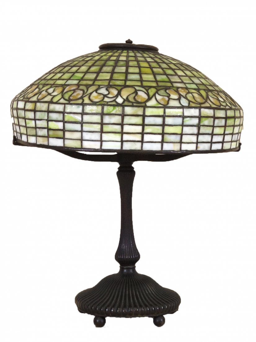 Tiffany Studios NY Leaded Glass Lemon Leaf Table Lamp: Fitted with domical shade, lemon leaf pattern, in shades of green, white and carmel, signed Tiffany Studios, shade signed Tiffany Studios New York, approximate diameter 18" raised on bronze 3 arm base