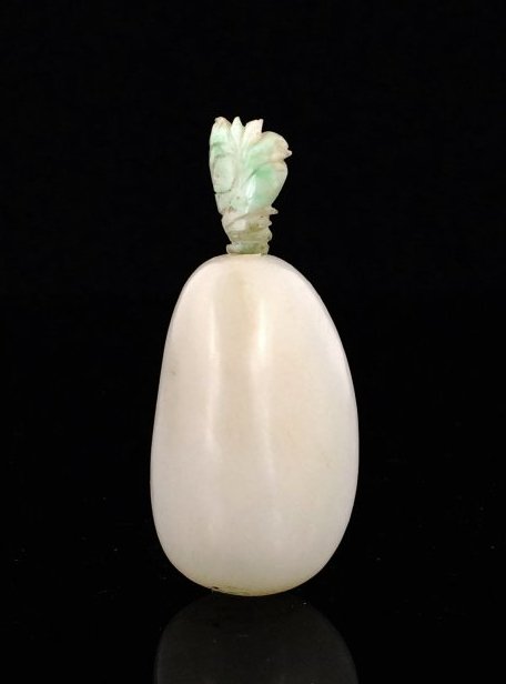 CHINESE WHITE JADE SNUFF BOTTLE, 19TH C: Of pyramid oval shape, and the softly polished stone is of even crÃ¨me white color. Dimension: 75mm H, approximately 54 grams.