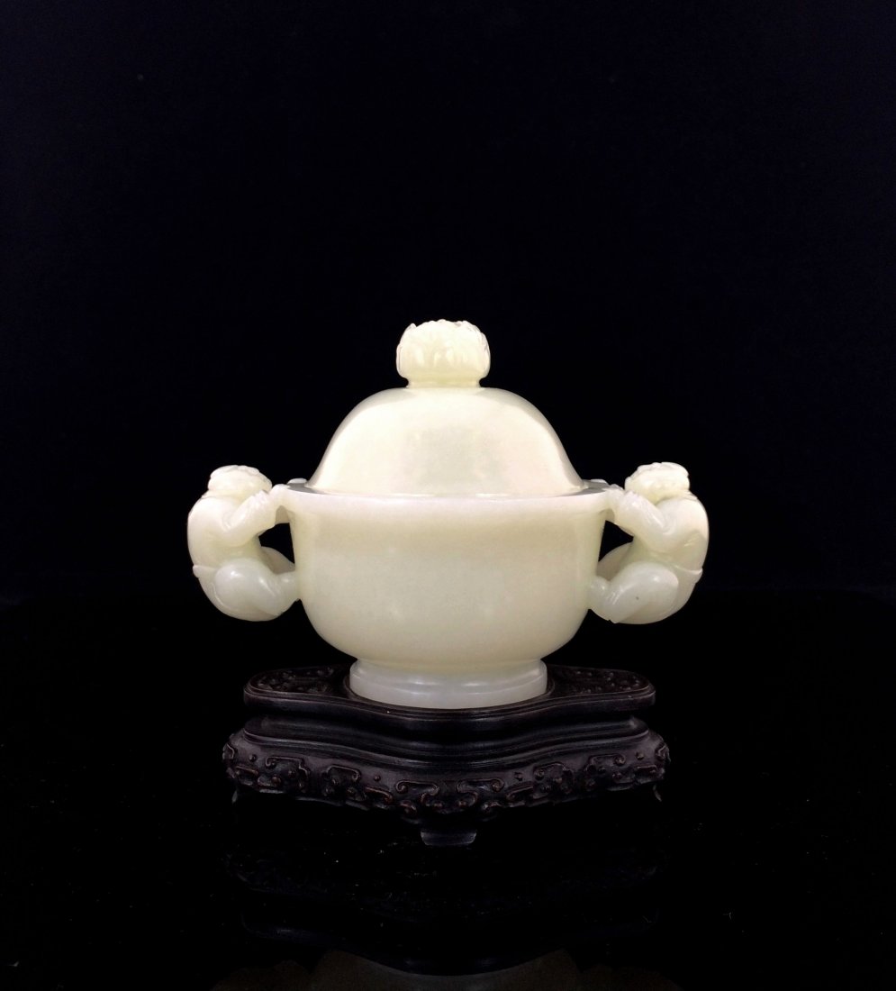 A FINE CARVED WHITE JADE COVERED CENSER W/ EAGLE: Chinese Carved White Jade Covered Censer. White Jade carved in globular shape body, raised on foot ring. domed lids with lotus buds handle on center top. Eagles handle flanked on shoulder with its win