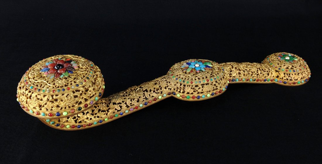 A JADEITE-INLAID CHAMPLEVE - GILT- RUYI SCEPTERS: Antique, Chinese UNUSUAL JADEITE-INLAID AND CHAMPLEVE -DECORATED GILT-COPPER RUYI SCEPTERS; 18th/19th Century. The scepter formed by an openwork frame of intricately cast gilt-copper within beaded bor