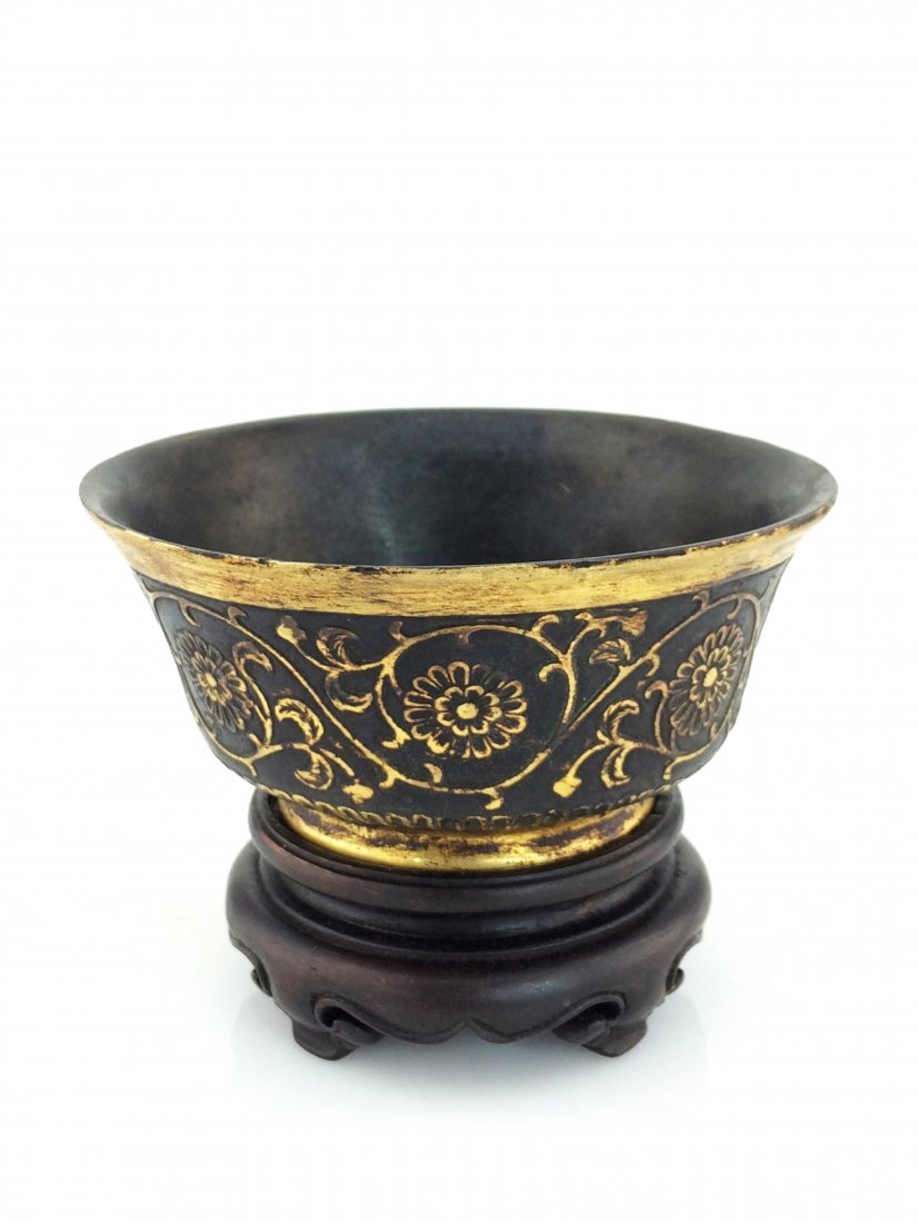 CHINESE GILT BRONZE BOWL ON STAND, 18th/19th C: Chinese Gilt Bronze Bowl, 18th/19th Century. Casted in a bowl shape, slightly flared rim, flat base and flat opening. Body adorned with gilt rococo scrolling foliage in low relief between two gilt ban