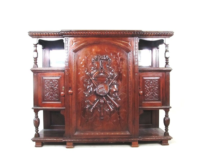 Walnut sideboard: Walnut server with carved wood.Carving has horns and flute on the main door. Nice beveled mirror accents this piece the two pieces together create that special look for any formal dining area.52" wide