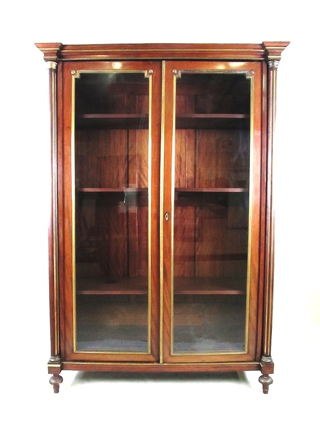 Mahogany 2 Door Book Case: Magnificent Mahogany book case with 4 adjustable shelves. Doors have metal banding around the glass. Column corners and a touch of glamour. 54" wide 78" tall 19" deep