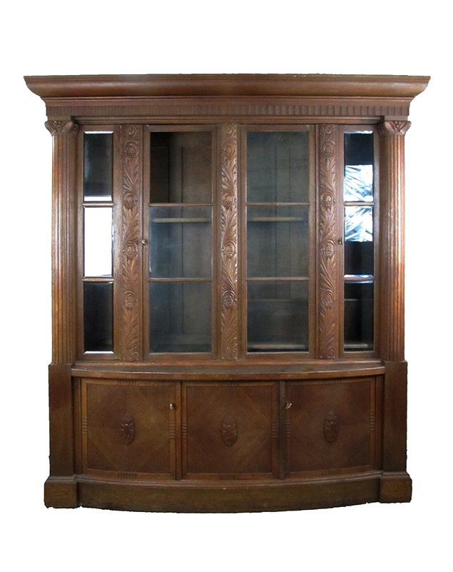 Oak Book Case: Oak book Case 4 door with column side pillars. Base is bow front designTypical heavy constructed cabinet Doors have Piano hinges.